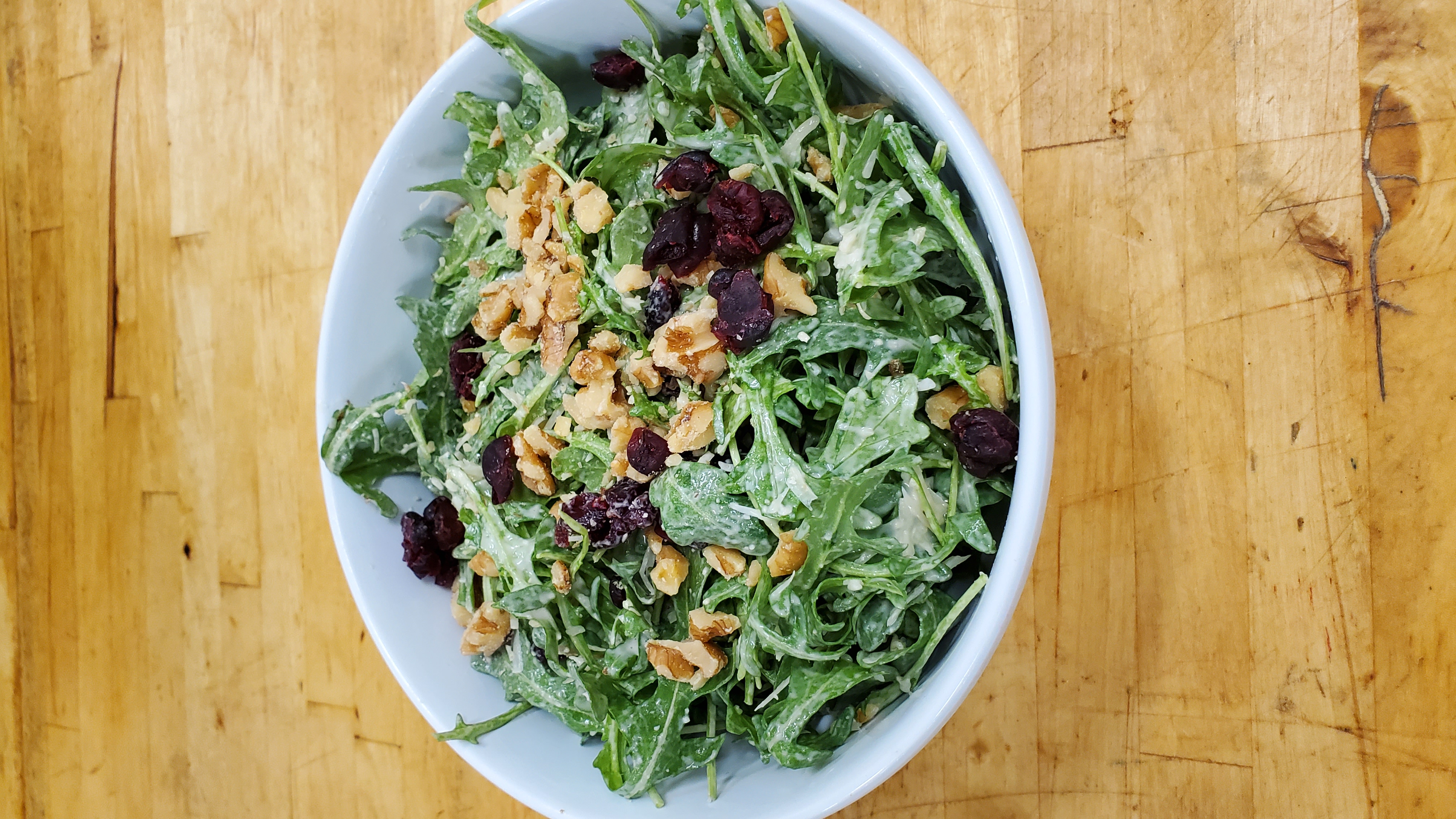 Order Arugula salad with walnuts and cranberries 9" container  food online from Seasoning Alley store, Monrovia on bringmethat.com