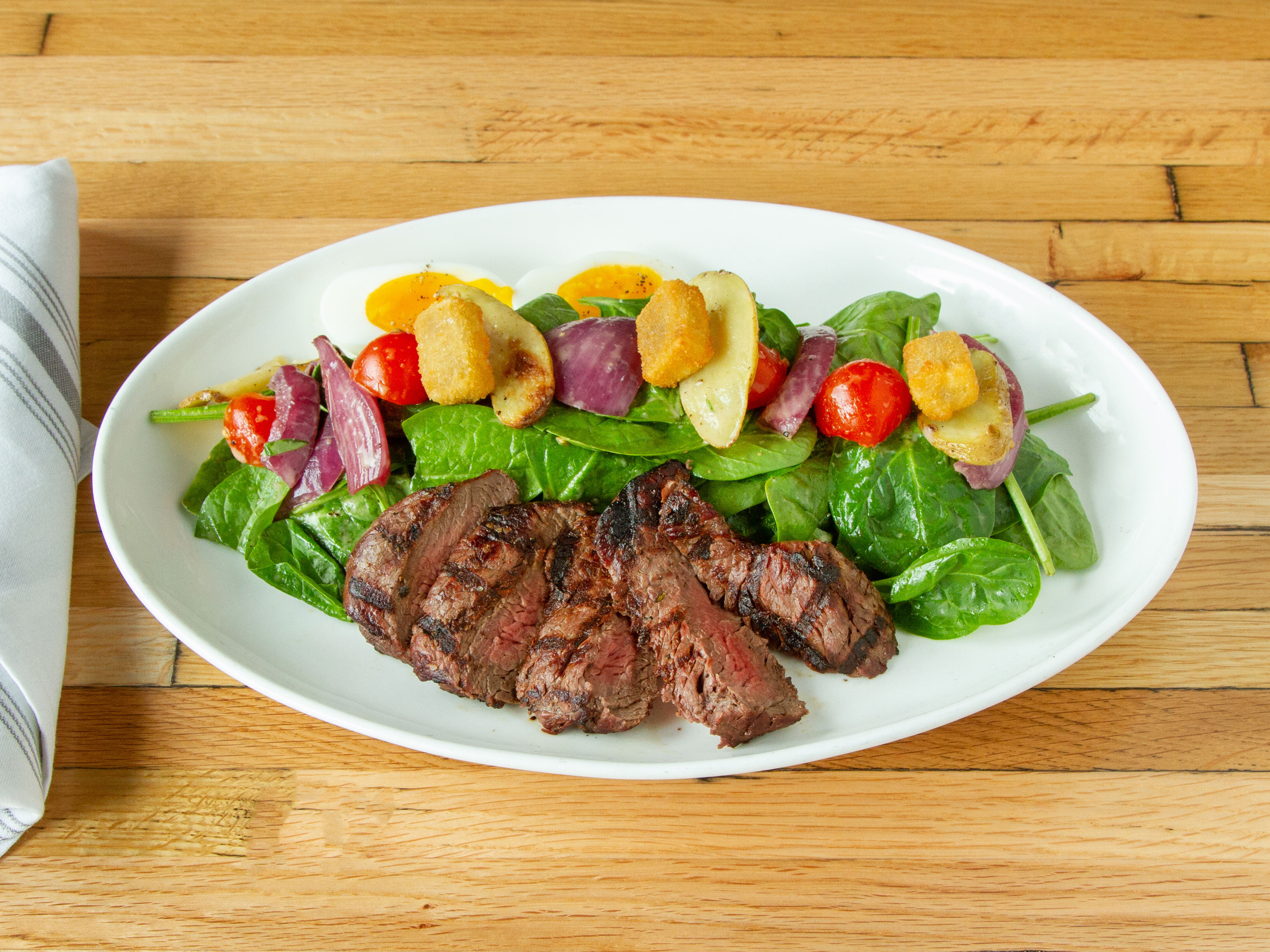 Order Steak + Spinach Salad food online from District 118 Kitchen And Bar store, Newton Upper Falls on bringmethat.com