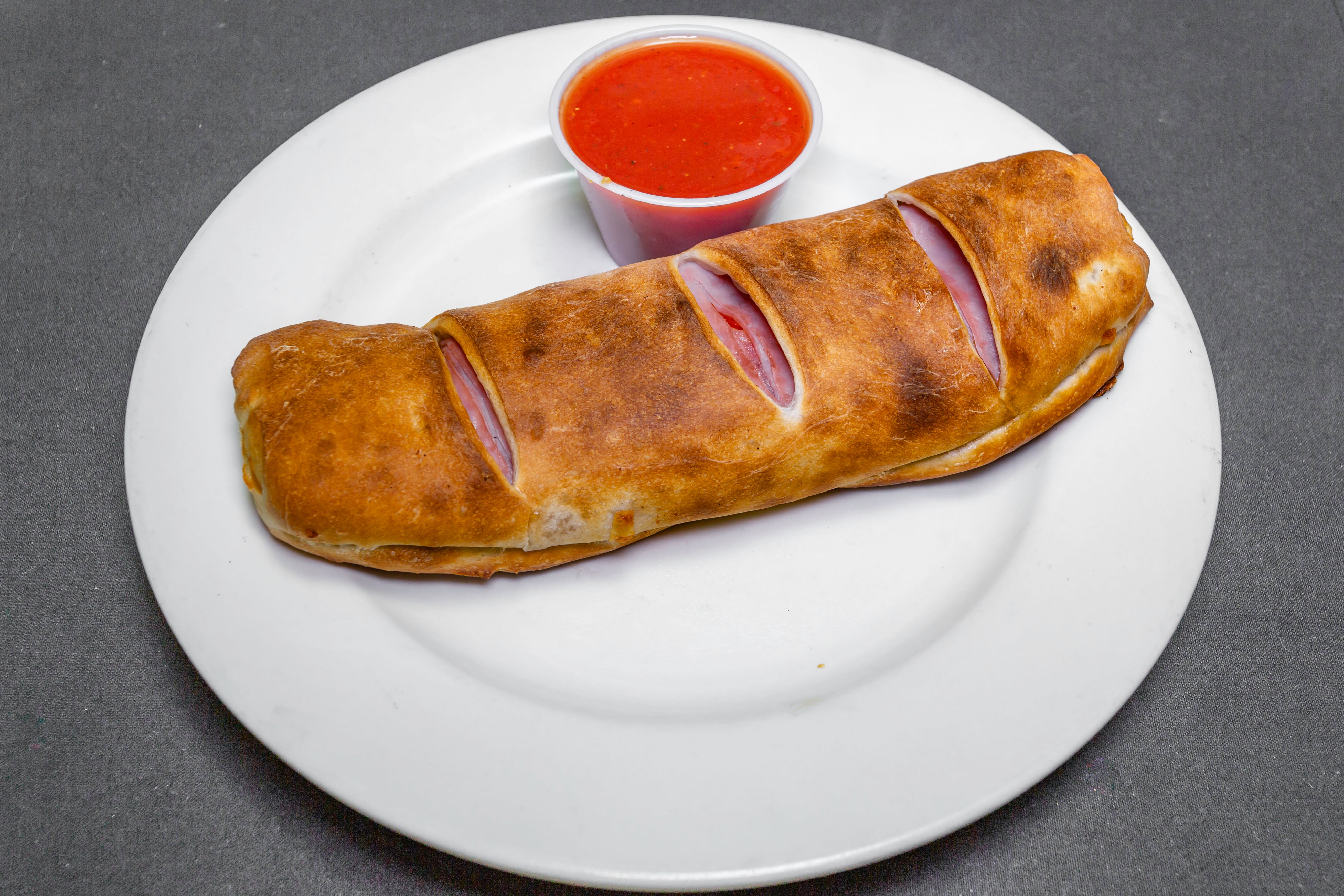 Order Ricotta & Cheese with Ham Calzone - Large food online from Pizza Como store, Lehighton on bringmethat.com