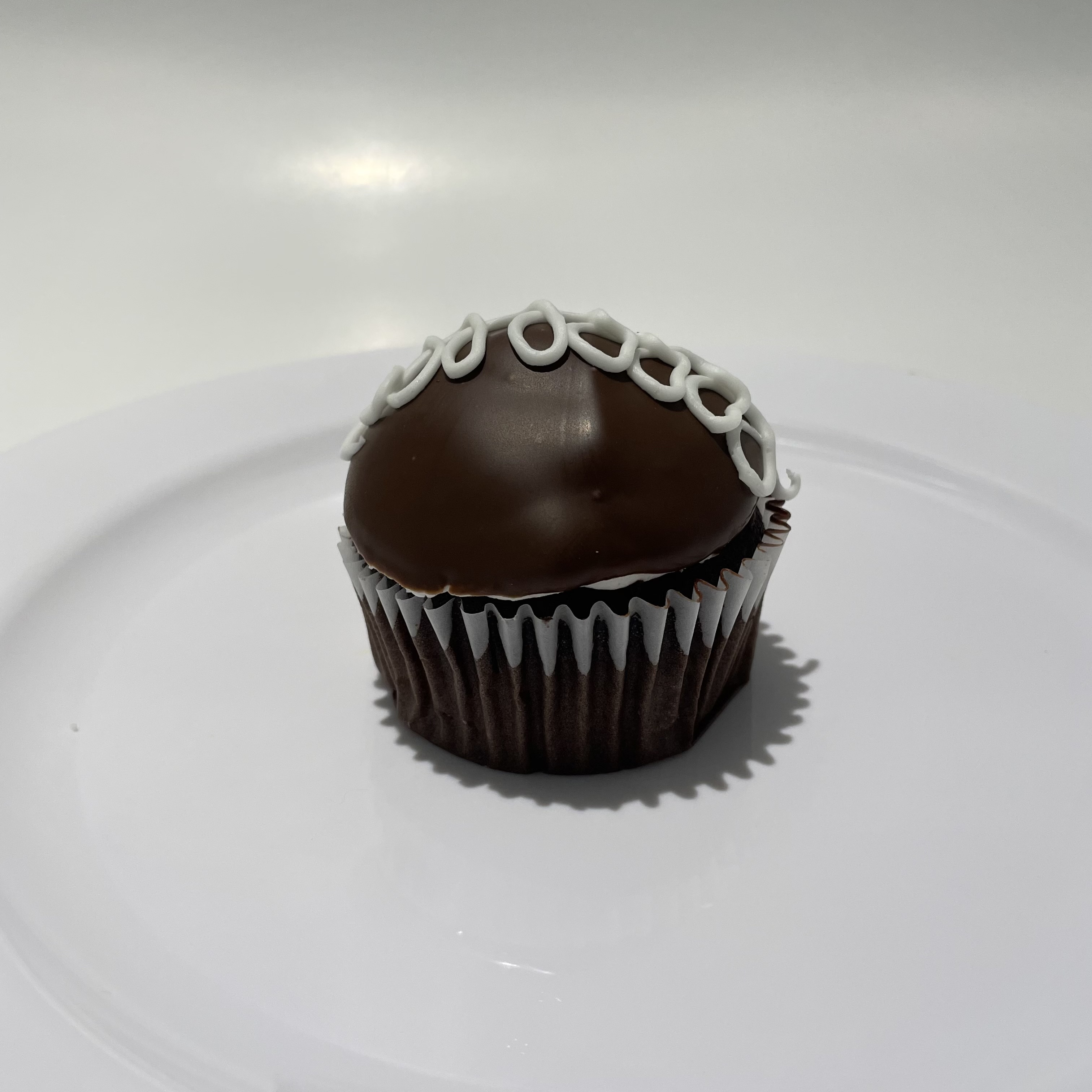Order Chocolate Cream Filled Cupcake food online from The House of Cupcakes store, Princeton on bringmethat.com