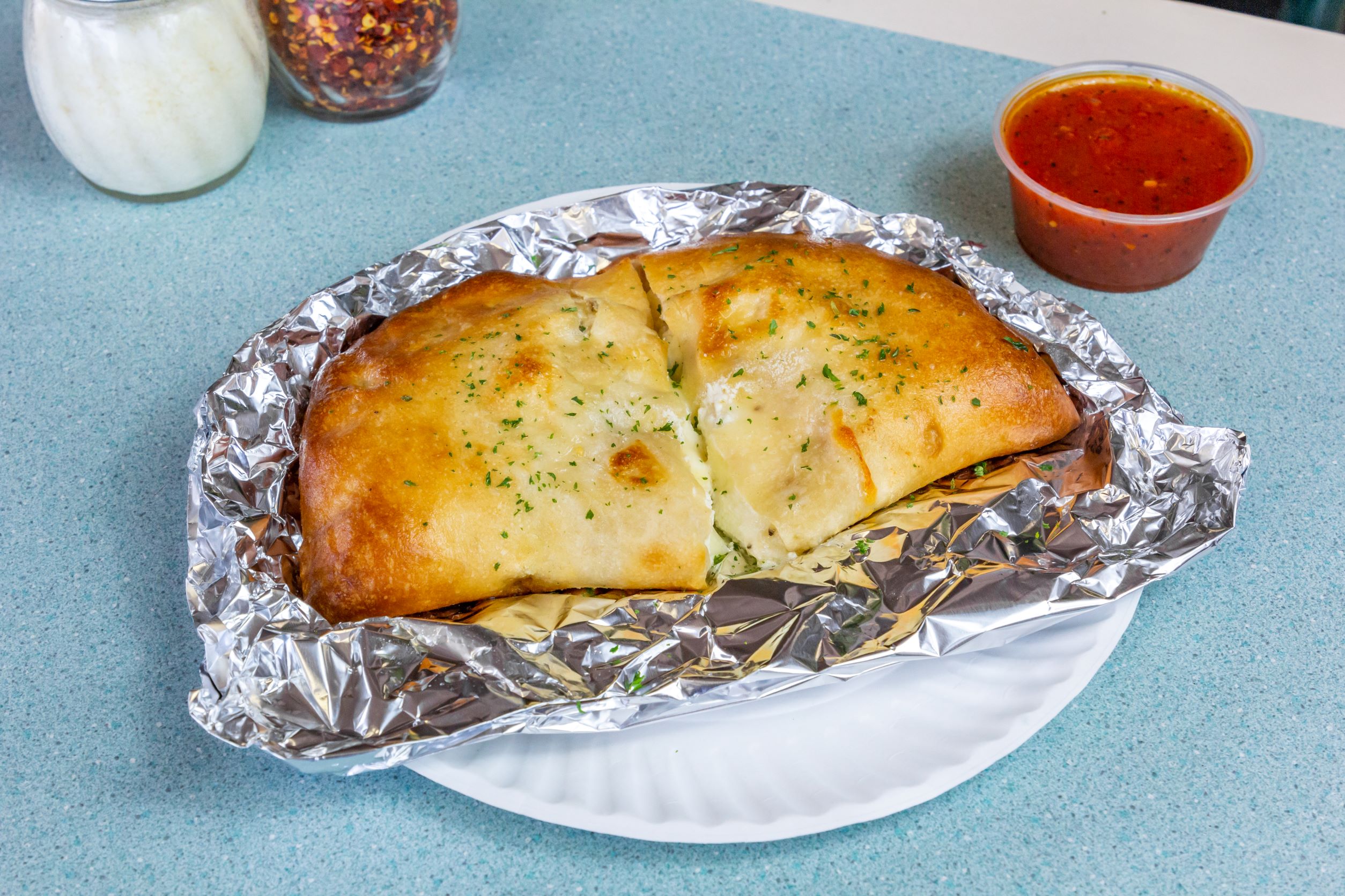 Order Three Cheese Calzone food online from Elias Pizzeria store, East Greenbush on bringmethat.com