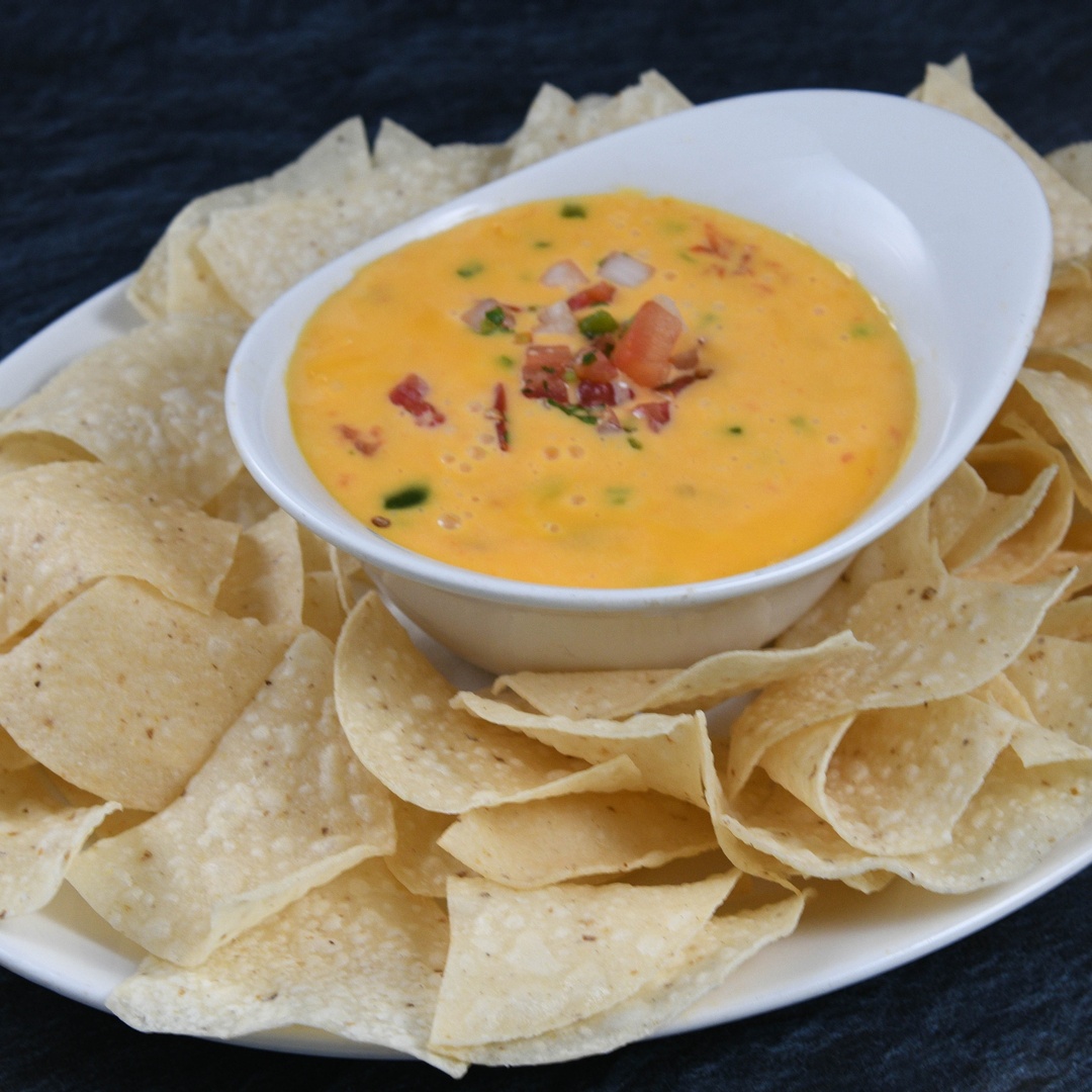 Order Chili Con Queso* food online from Rainforest Cafe store, Las Vegas on bringmethat.com