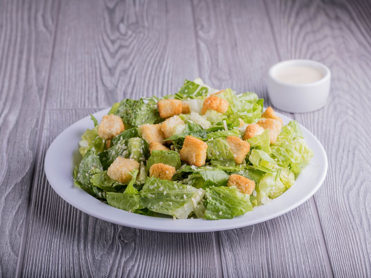 Order Caesar Salad food online from Round Table Pizza store, San Diego on bringmethat.com