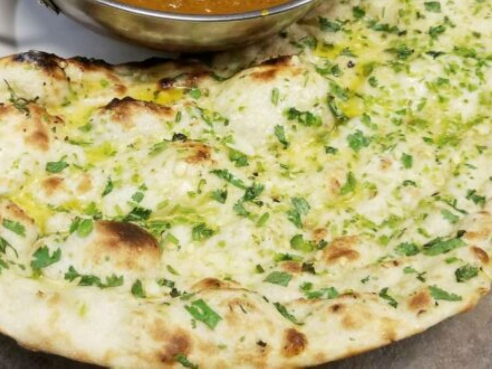 Order Garlic Naan food online from Passage to India store, Cambridge on bringmethat.com