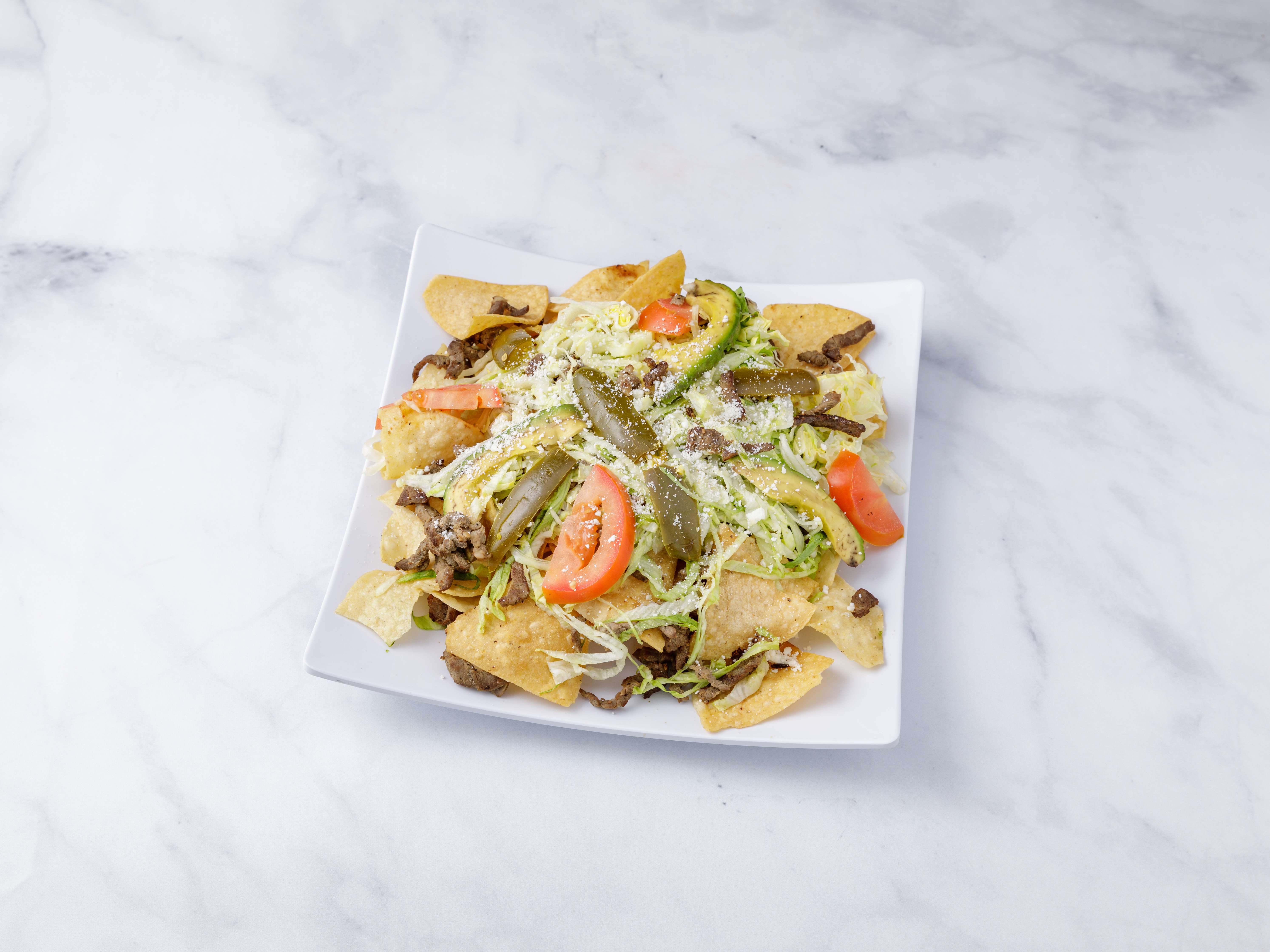 Order Nachos with Choice of Meat food online from Reyes Mexican Deli Inc. store, Bronx on bringmethat.com