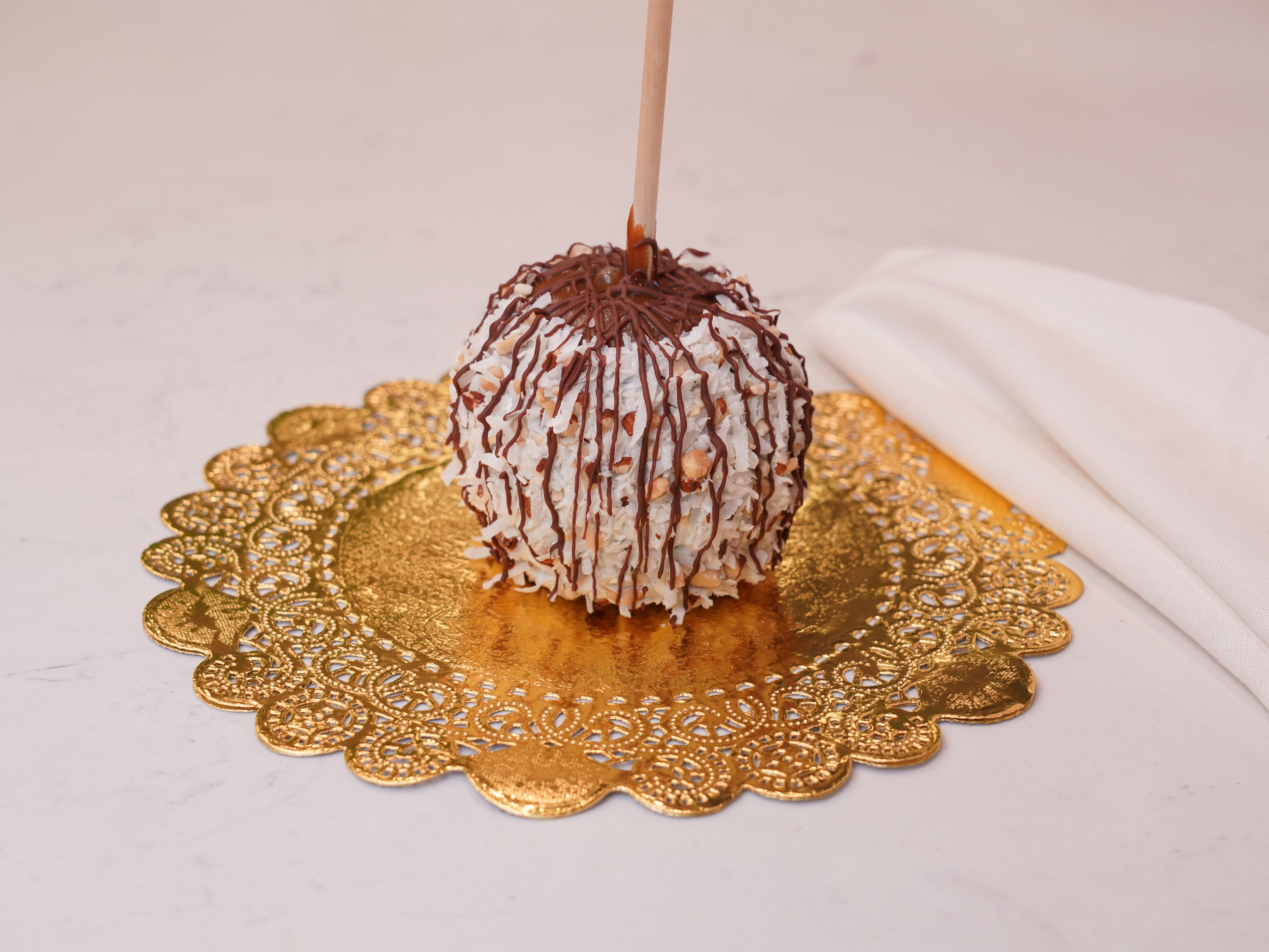 Order Coconut Almond Caramel Apple food online from Chocolate Wishes And Treats store, Clovis on bringmethat.com
