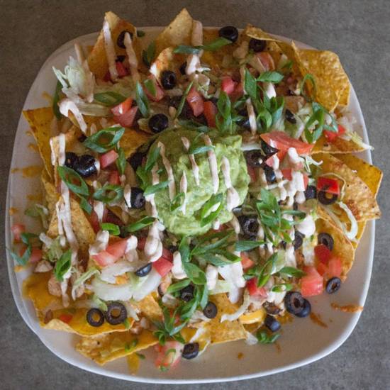 Order Deluxe Nachos* food online from Uccello Ristorante store, Grand Rapids on bringmethat.com
