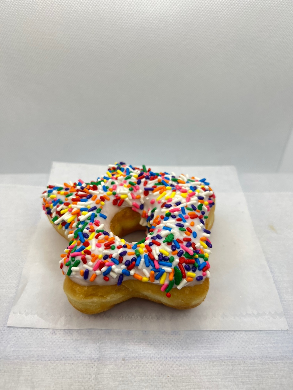 Order Star sprinkle donut food online from Fresh & Creamy Donuts store, Lewisville on bringmethat.com