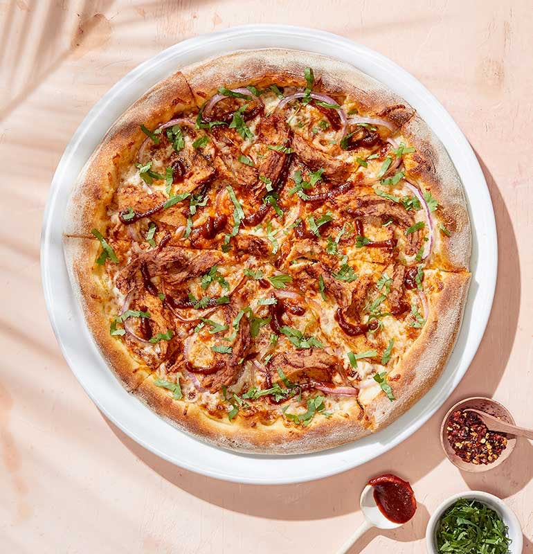 Order PLANT-BASED BBQ CHICKEN PIZZA food online from California Pizza Kitchen store, Hollywood on bringmethat.com