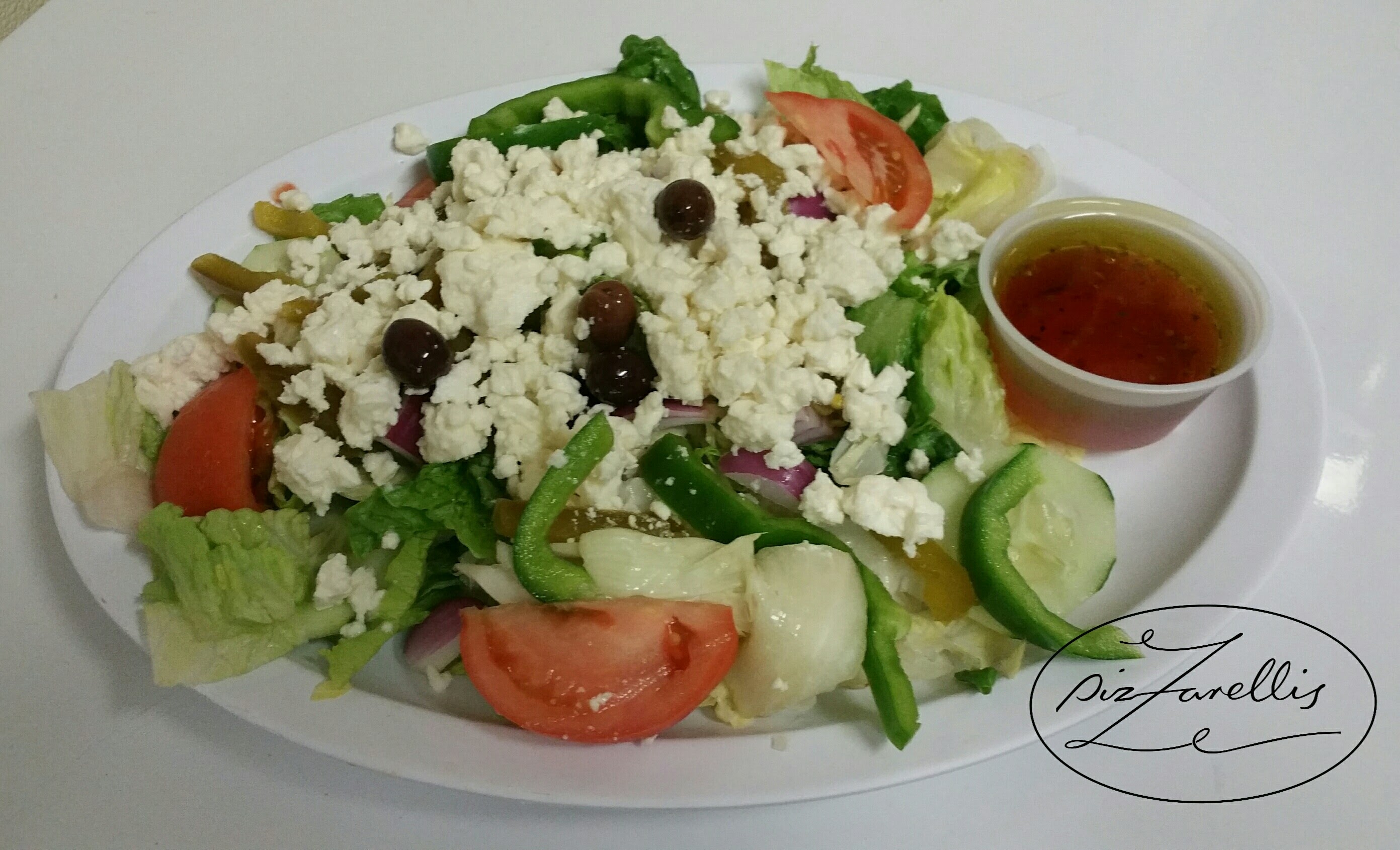 Order Greek Salad food online from Pizzarelli's Pizza store, Scarsdale on bringmethat.com