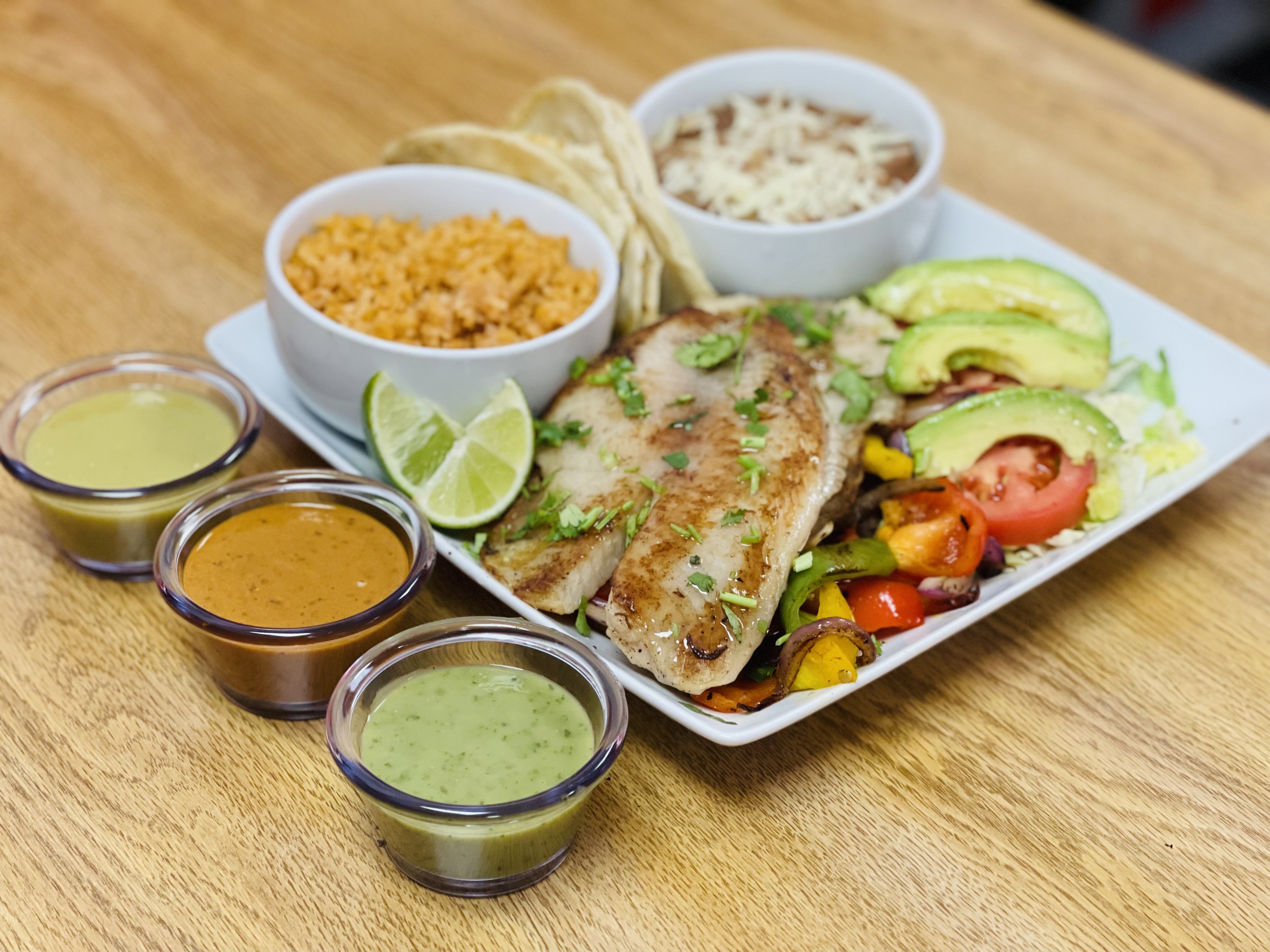 Order Tilapia + Rice and Beans Plate food online from My Taco House store, Modesto on bringmethat.com