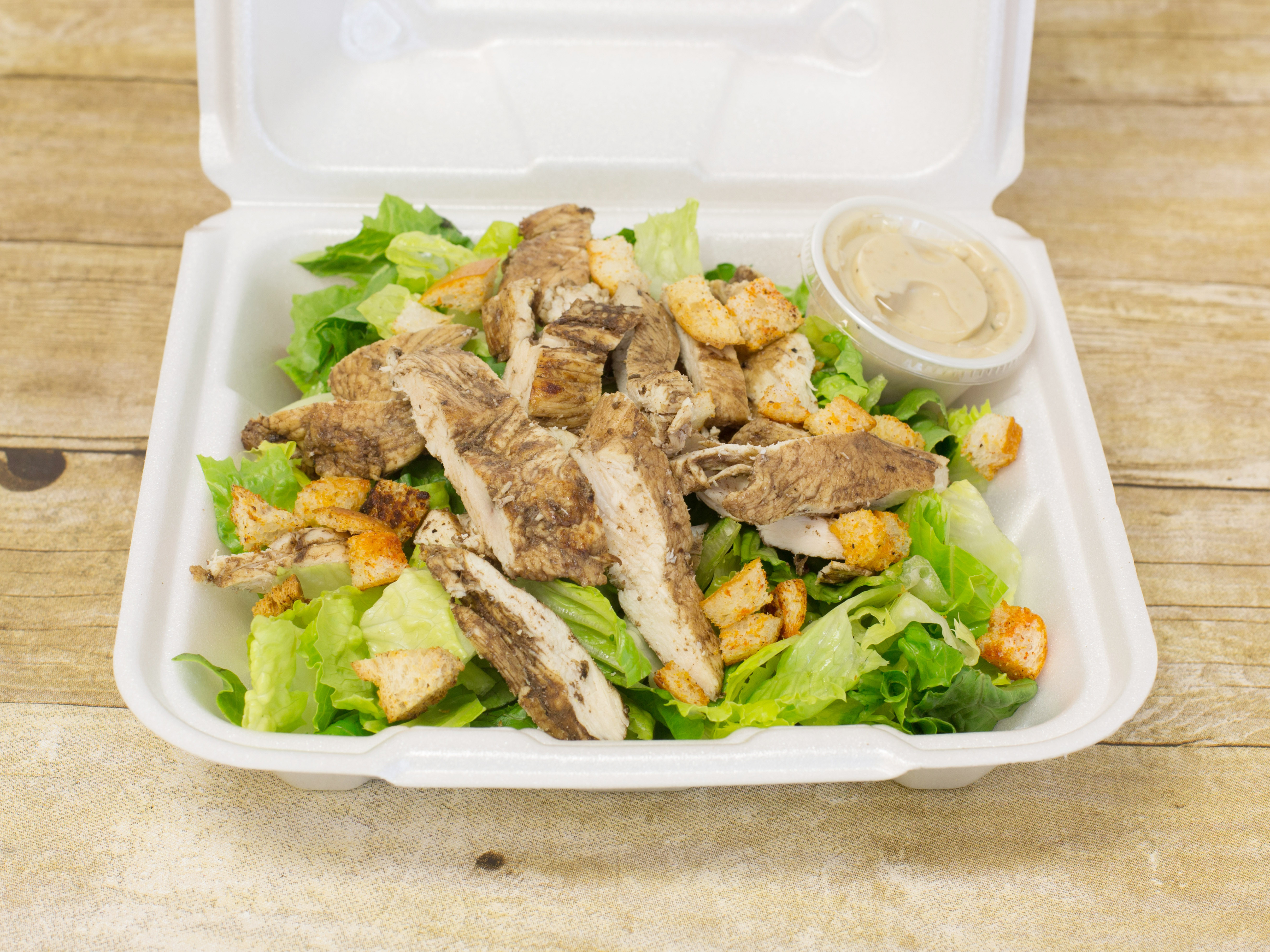 Order Caesar Salad with Grilled Chicken food online from Marco's Deli store, Metuchen on bringmethat.com