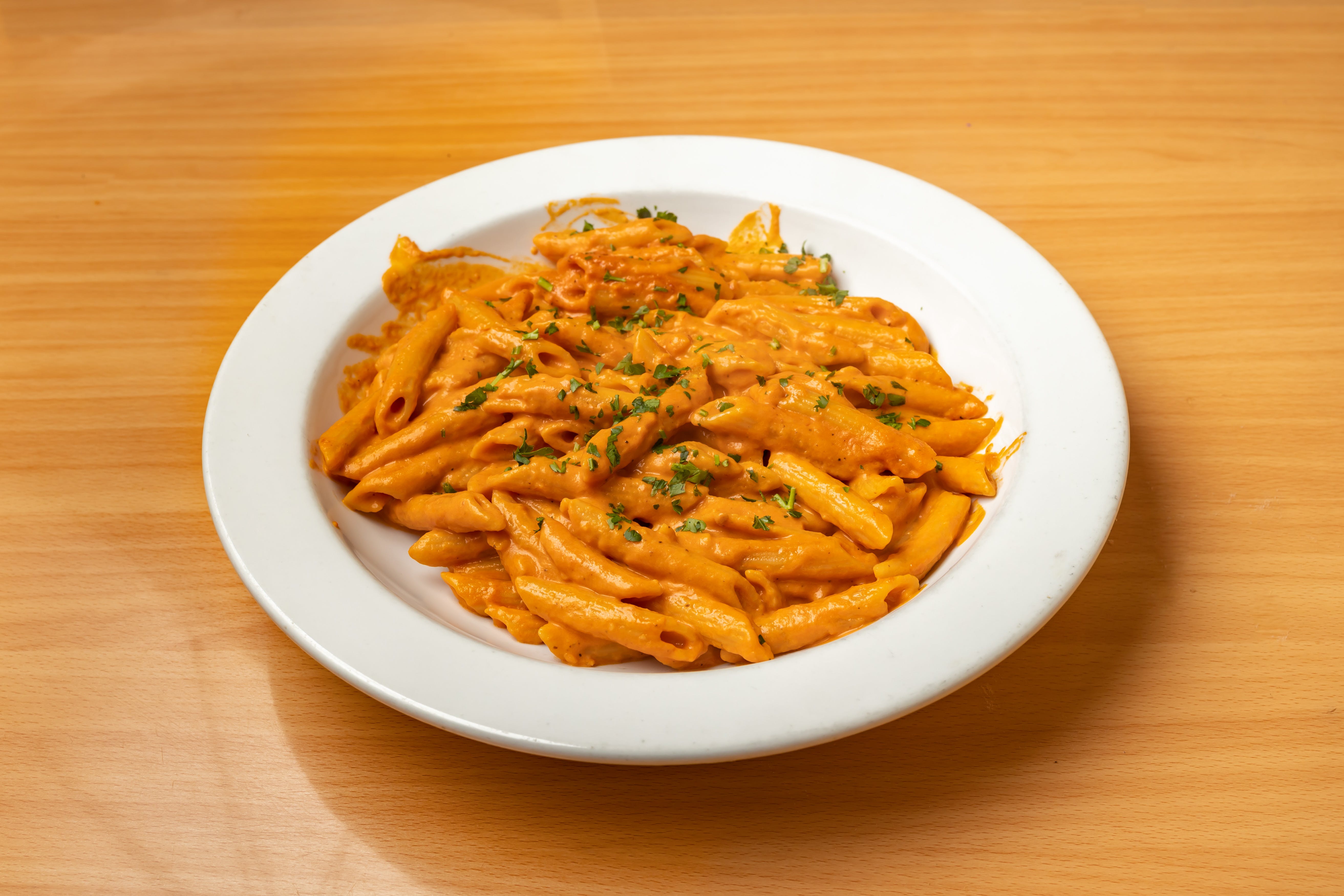 Order Penne Alla Vodka - Pasta food online from Valentino's store, Fresh Meadows on bringmethat.com