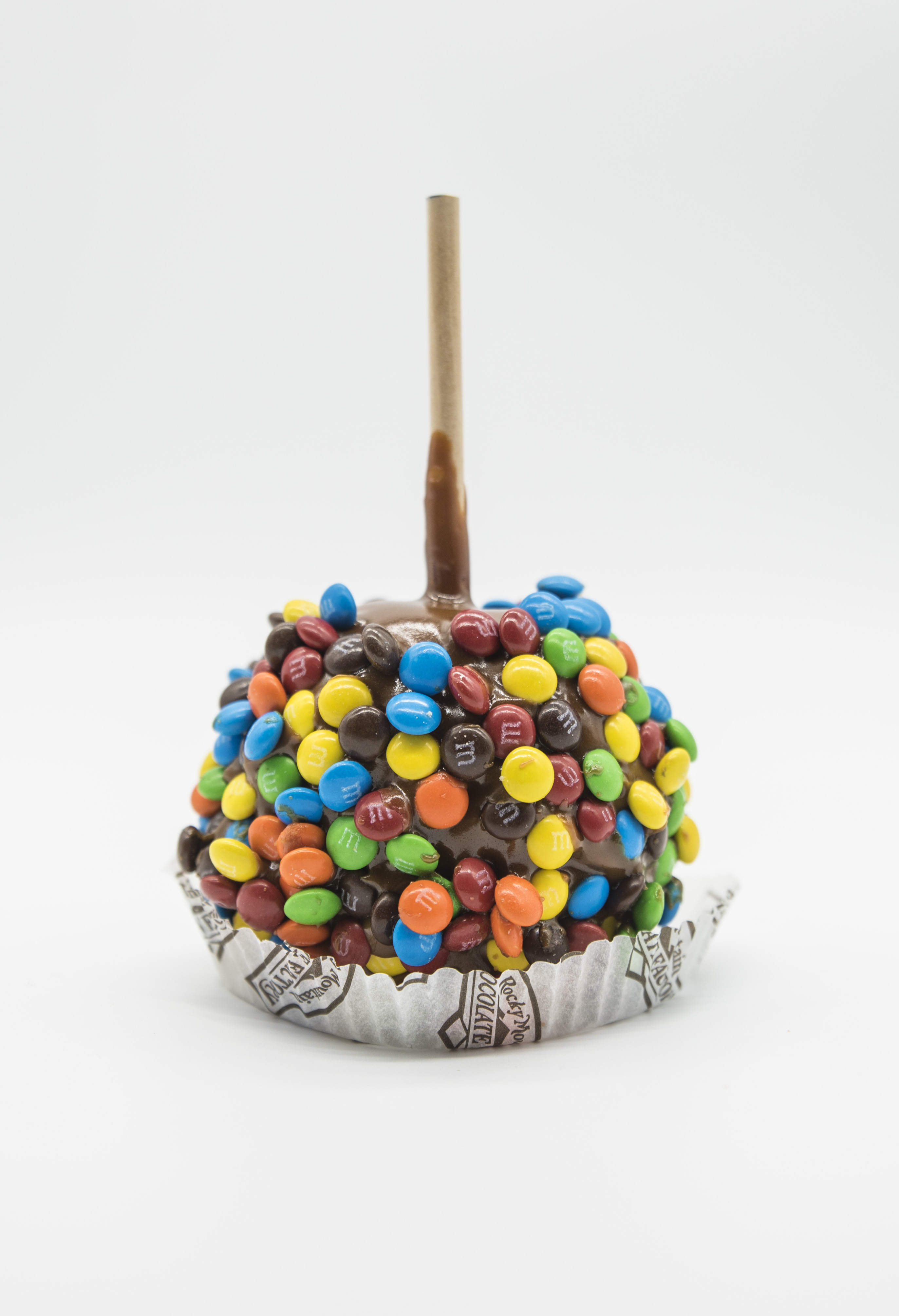 Order M&M’s Caramel Apple food online from Rocky Mountain Chocolate Factory store, Fresno on bringmethat.com