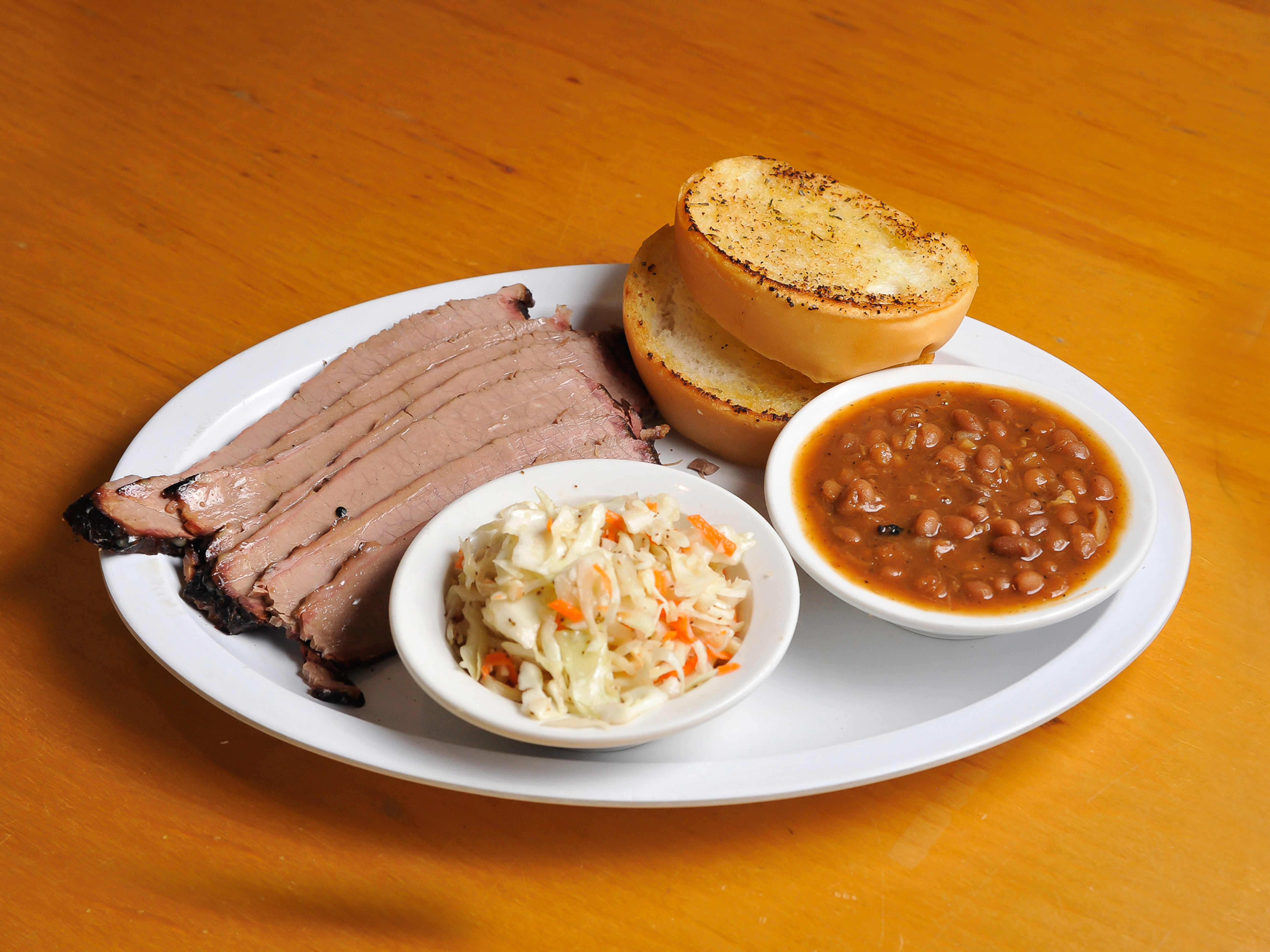 Order 8 oz. Beef Brisket Platter with 2 Sides and Garlic Bread food online from J Miller's Smokehouse store, Woodstock on bringmethat.com