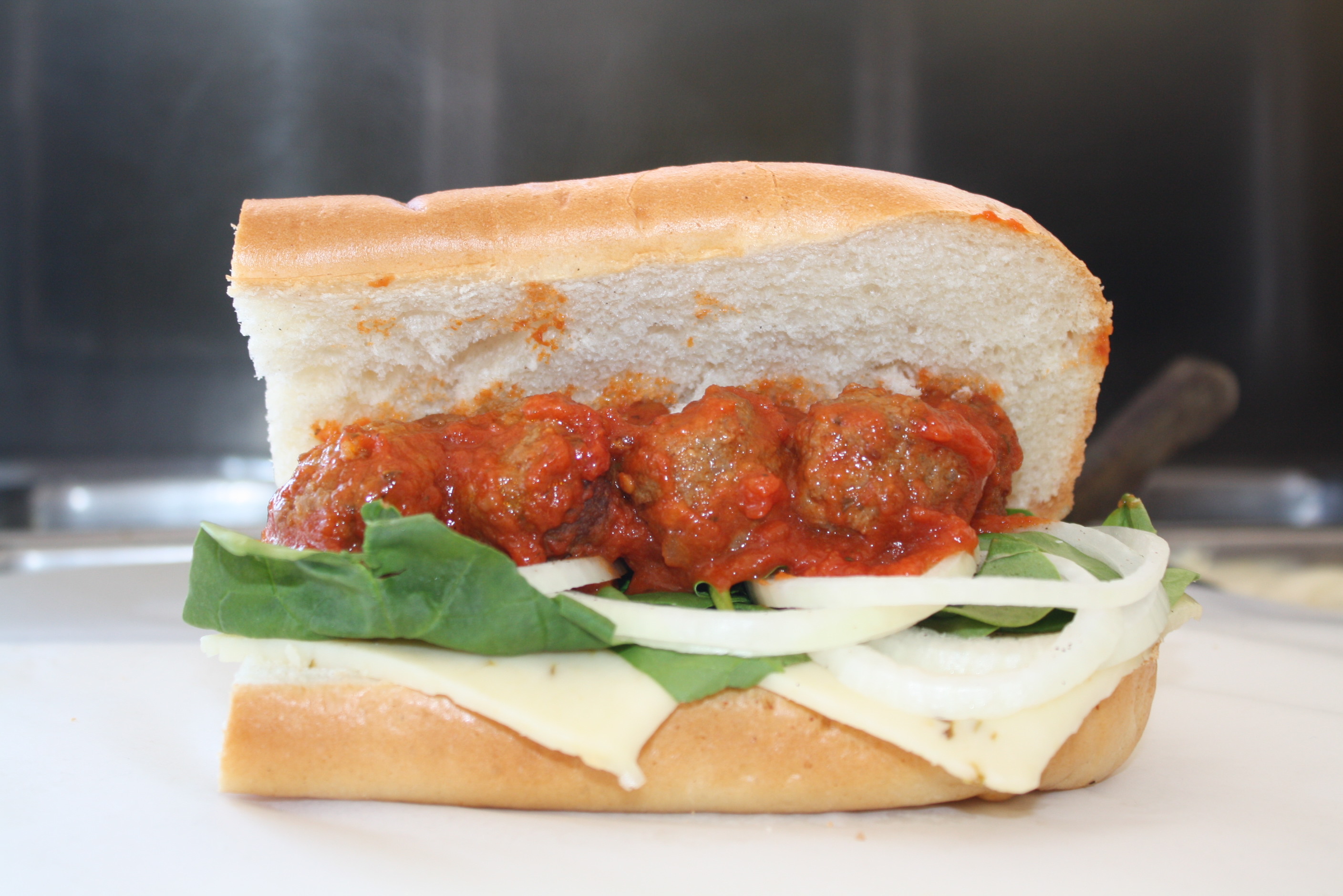 Order 24. Meatball Sub food online from College Sub Shop store, San Diego on bringmethat.com