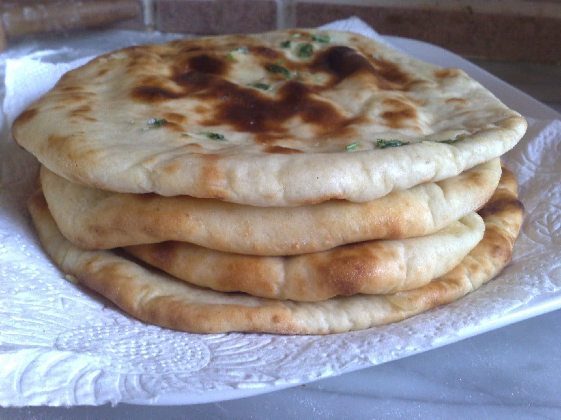 Order Butter Naan - Bread food online from Bombay Grill store, Seattle on bringmethat.com
