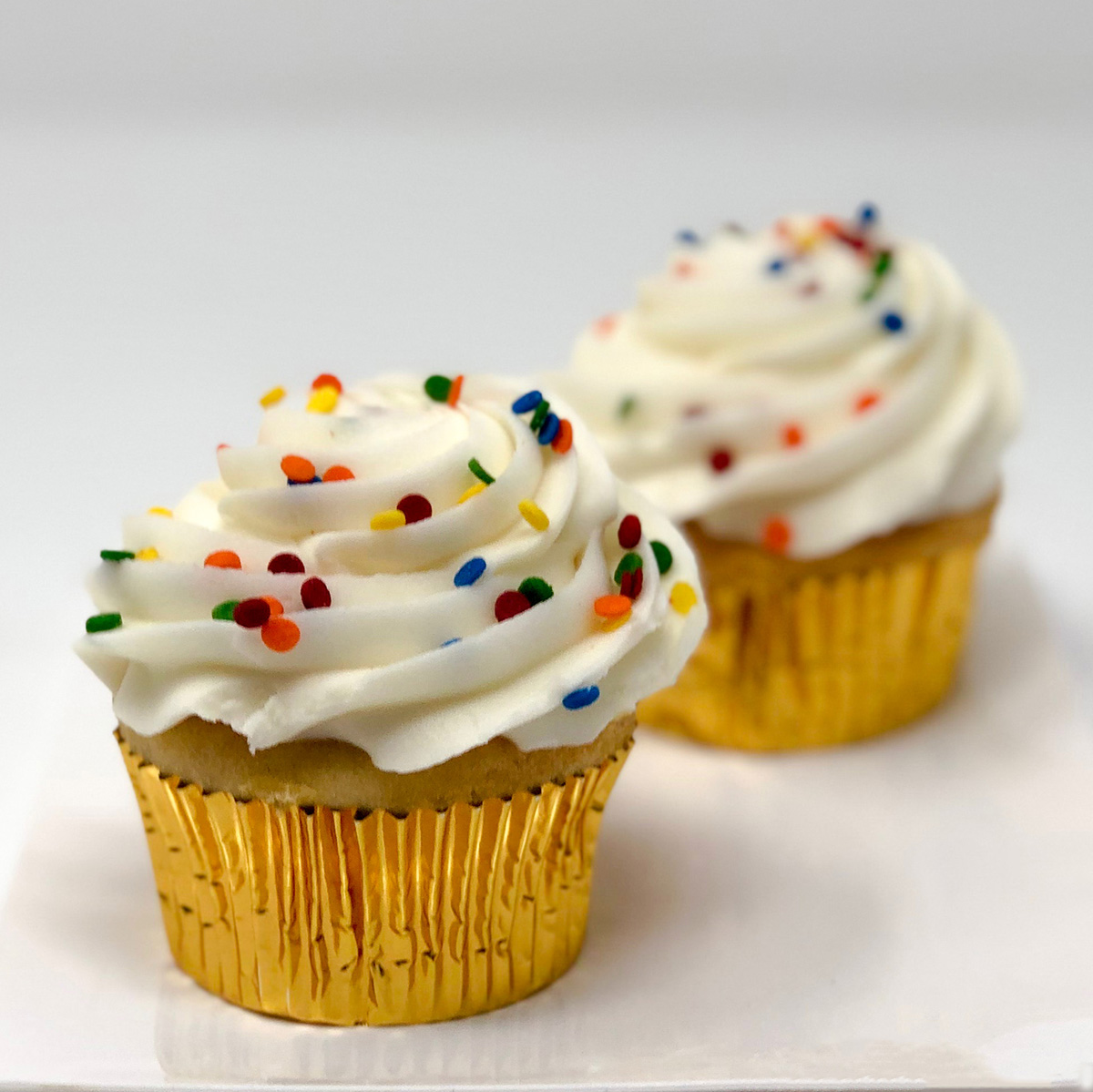 Order Sprinkled Cupcake - Vanilla food online from Merritt's Bakery  store, Tulsa on bringmethat.com