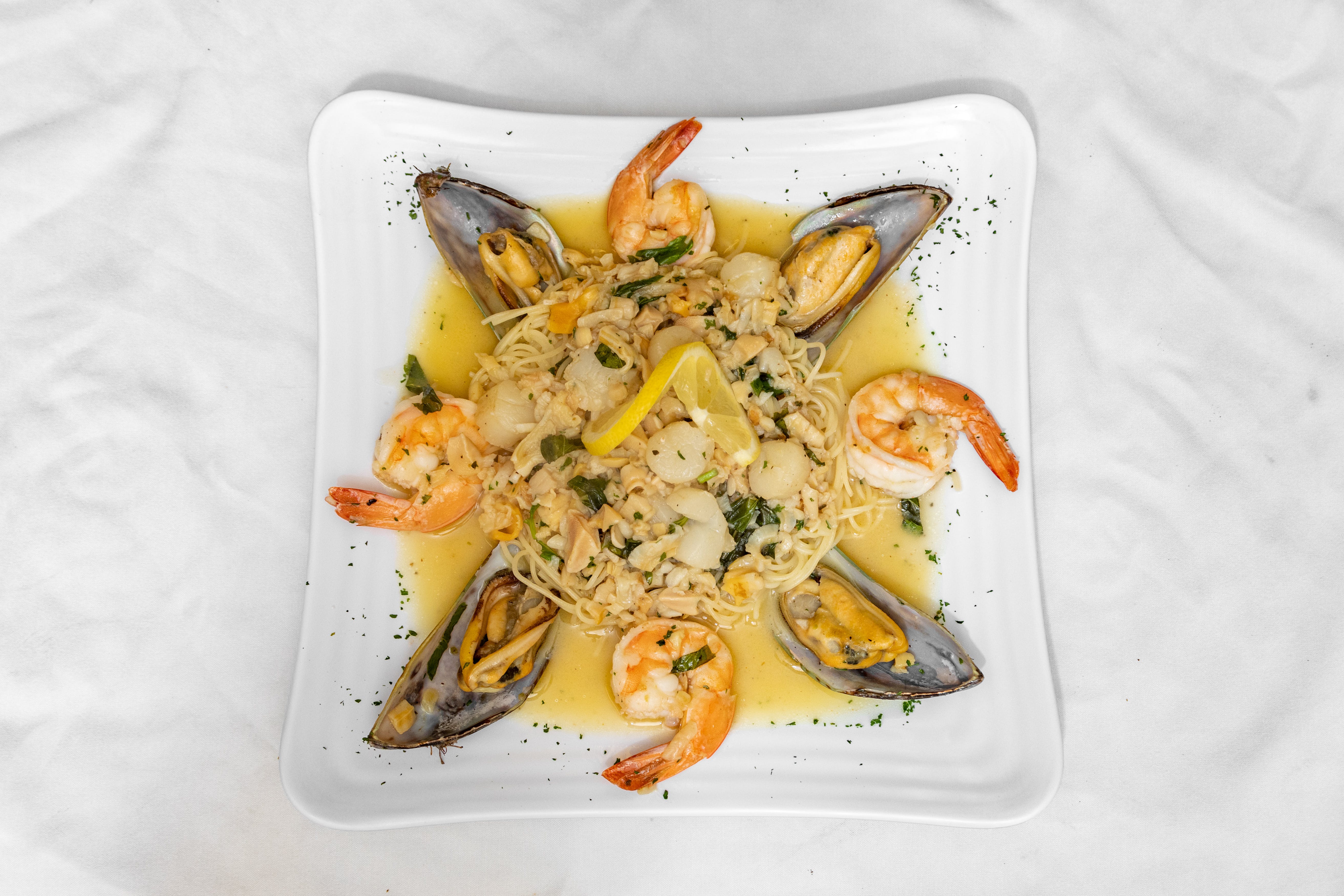 Order Seafood Combo - Entree food online from Nikis Italian Bistro store, Murphy on bringmethat.com