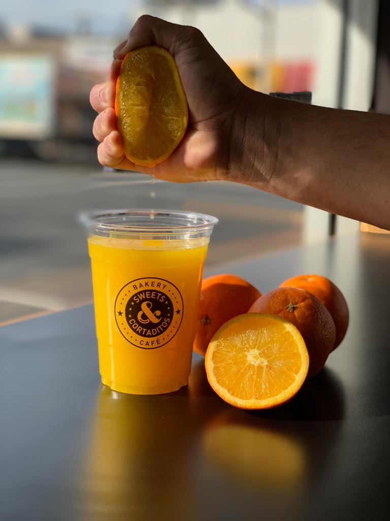 Order Fresh squeezed Orange Juice 16oz - Jugo de naranja Natural food online from Sweets & Cortaditos store, Belleville on bringmethat.com