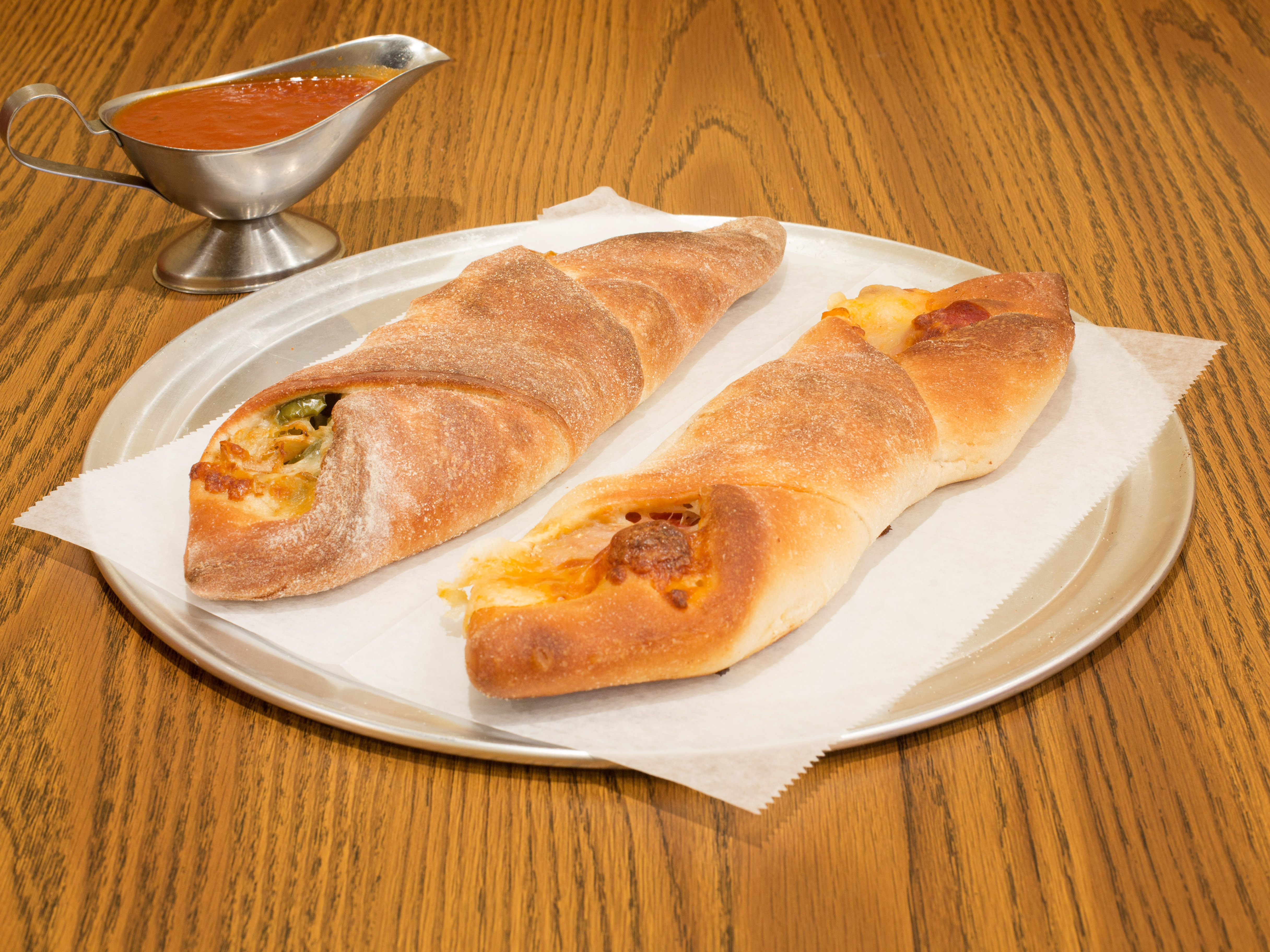 Order Sausage, Peppers, Onions and Mozzarella Roll food online from Puzo Family Restaurant store, North Haledon on bringmethat.com