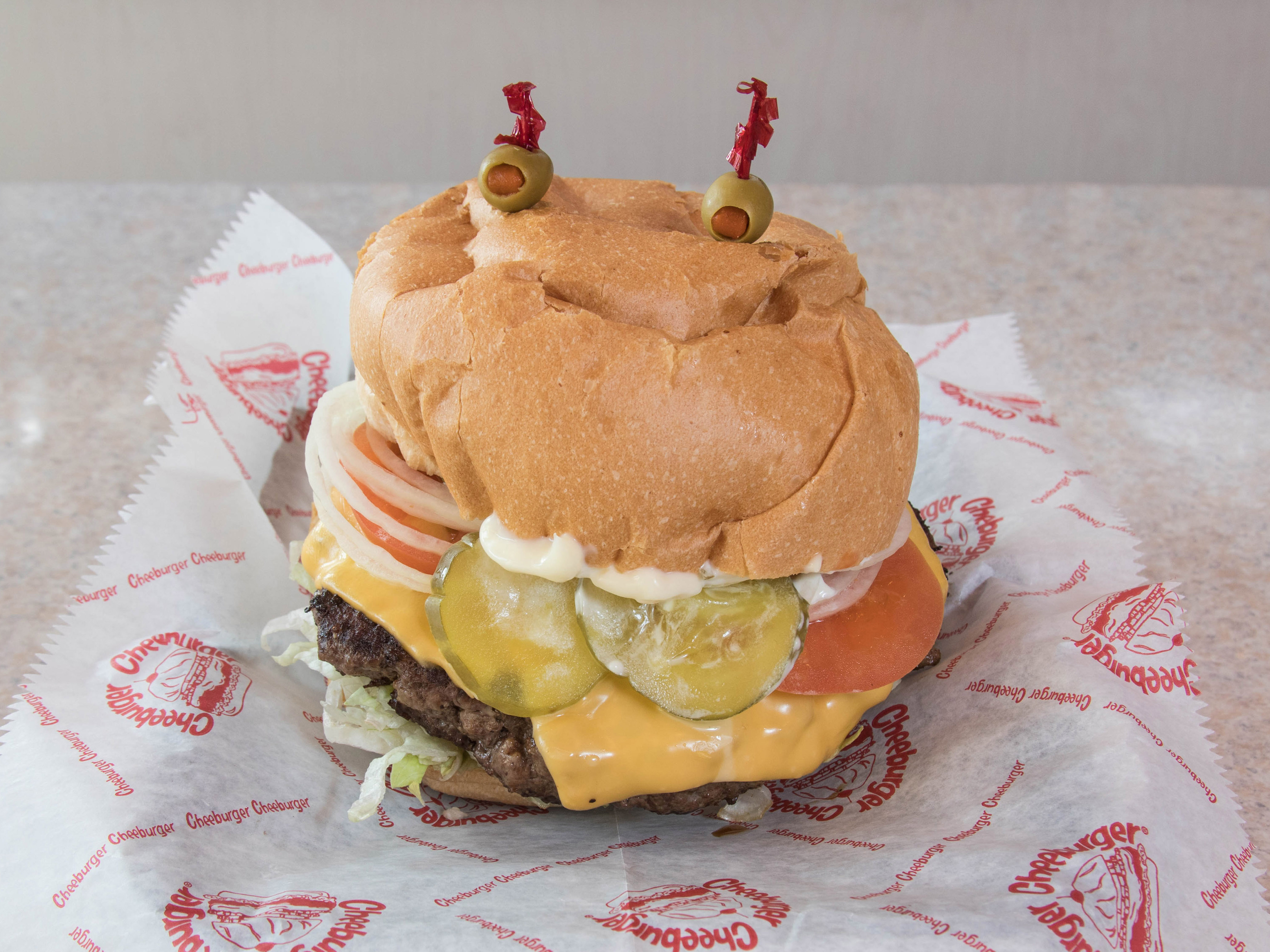 Order Our Famous Pounder Burger food online from Cheeburger Cheeburger store, Saint Louis on bringmethat.com