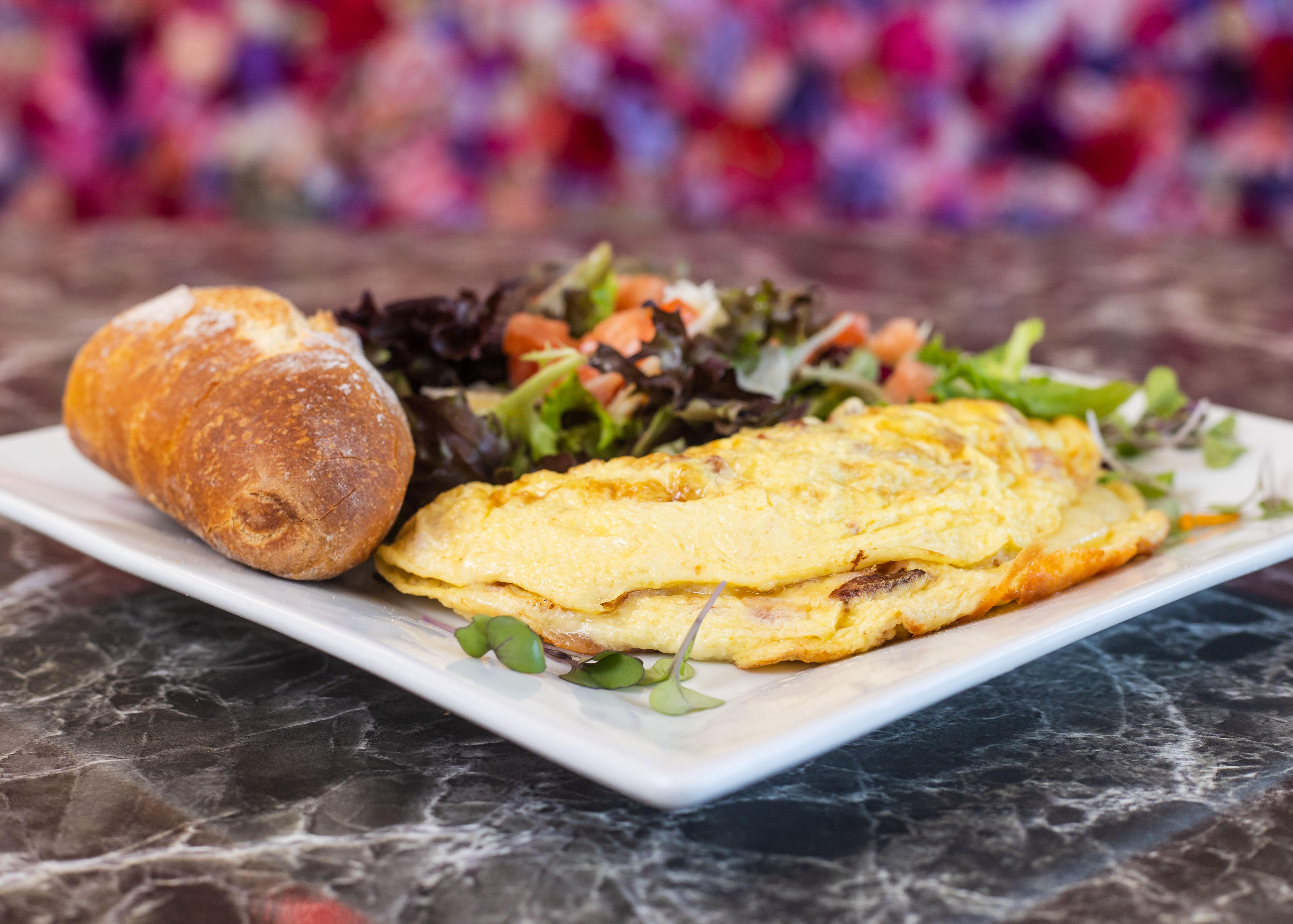 Order Ham, Bacon, Tomato & Goat Cheese Omelette food online from Rendez Vous store, Corona Del Mar on bringmethat.com