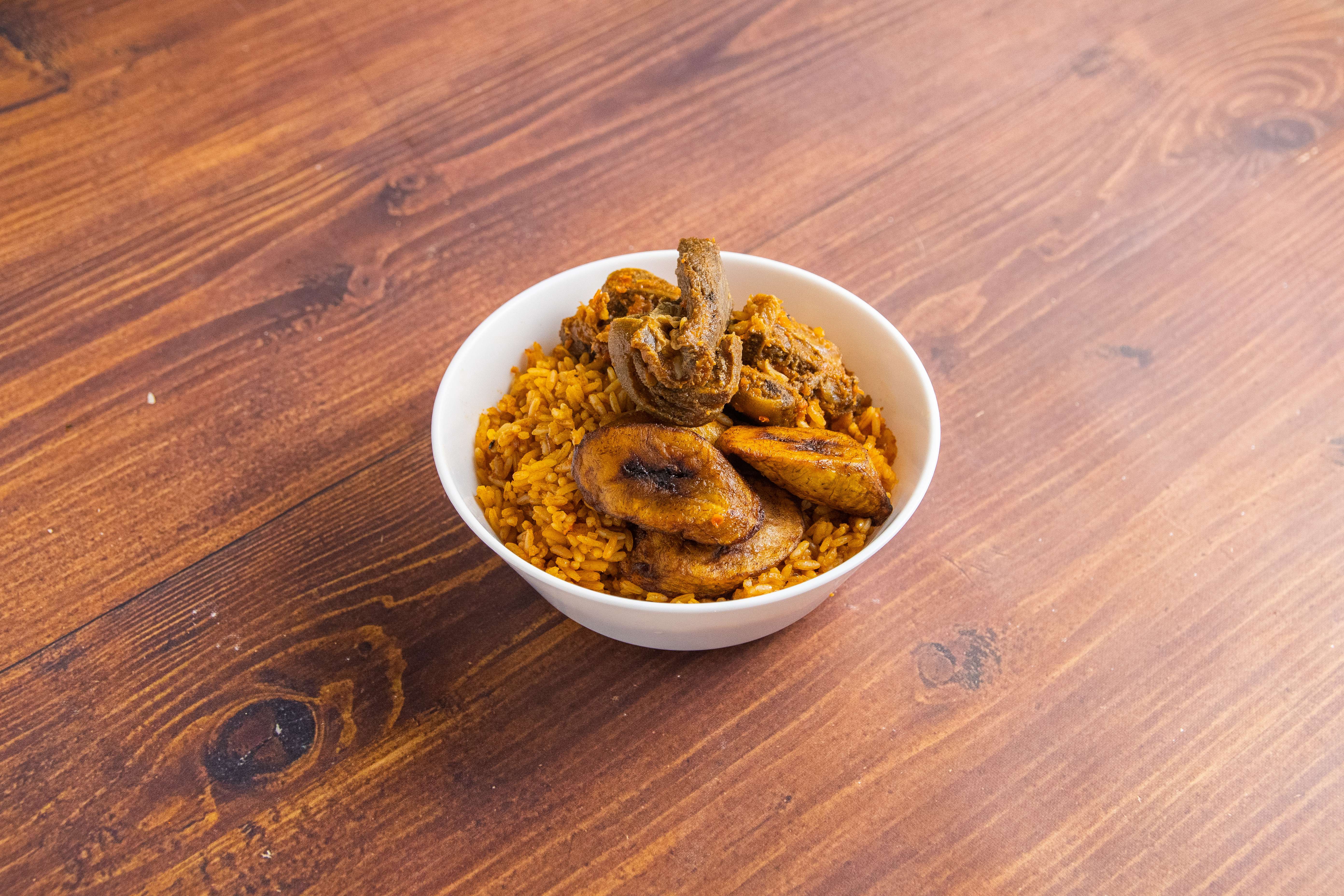 Order Jollof Rice Meal Combo(fried plantain) served with choice of either ...mixed beef, goat, fish or chicken food online from Sumptuous African Restaurant store, Inglewood on bringmethat.com