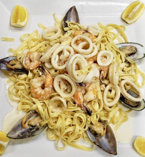 Order Seafood Fettuccine in White Sauce food online from Cafe Gourmand store, Staten Island on bringmethat.com