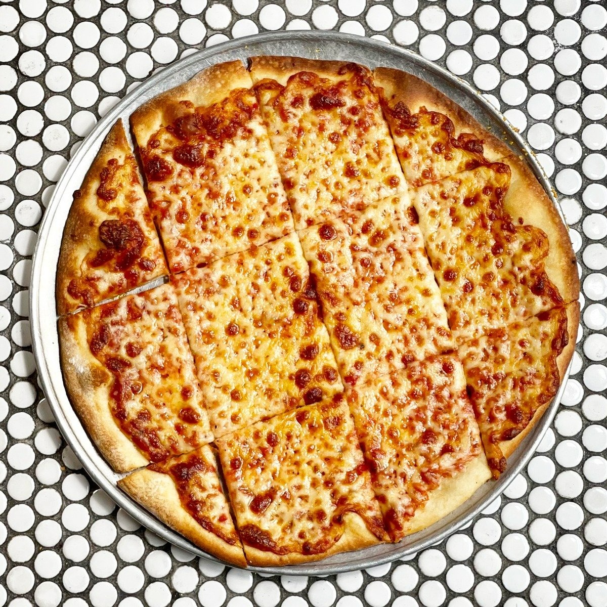 Order Build Your Own Thin Crust | 16" food online from Gino's East of store, Lake Geneva on bringmethat.com