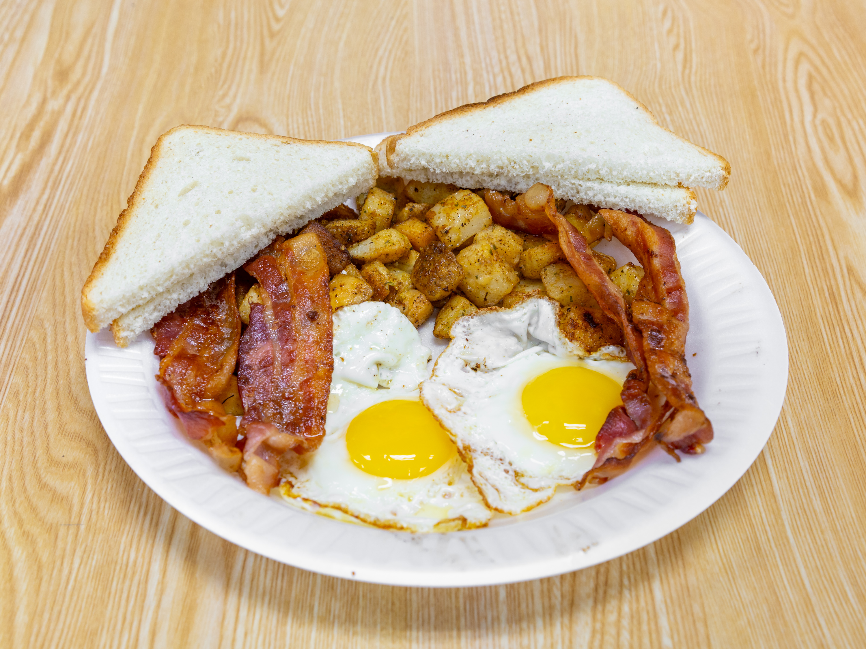 Order 2 Eggs with Meat, Potato, and Toast Platter food online from Bagel One store, East Brunswick on bringmethat.com
