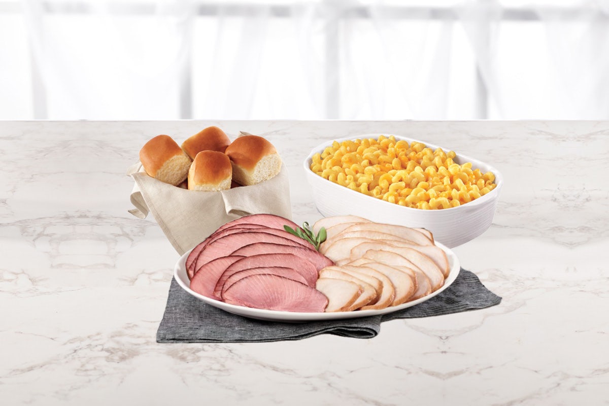Order 2lb Ham Slices Dinner (Double Cheddar Mac & Cheese Side Dish (simply bake or microwave) & a 4-pack of King's Hawaiian Rolls) food online from Honeybaked Ham store, Locust Grove on bringmethat.com