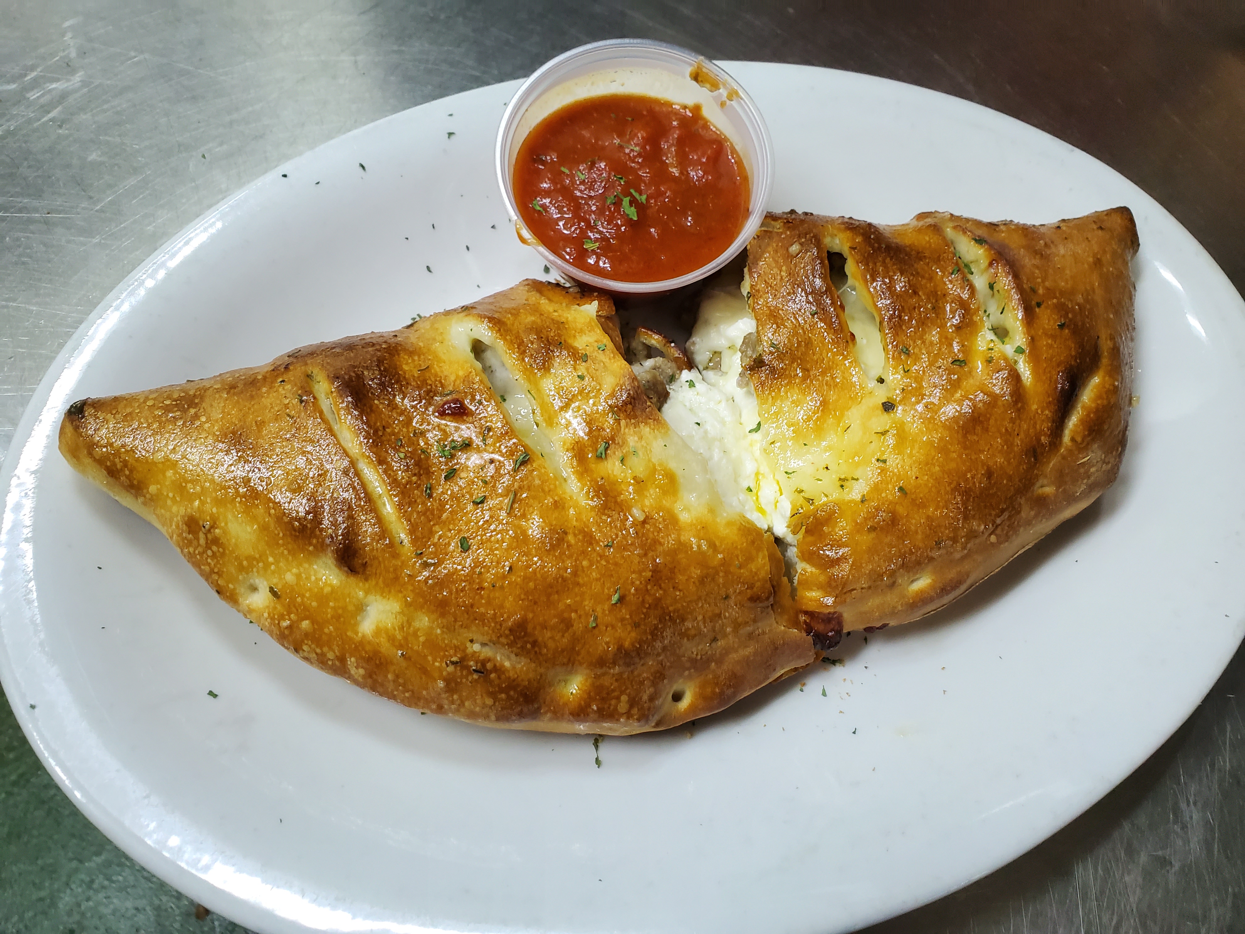 Order Meat Lovers Calzone food online from Pepes Pizza store, North Richland Hills on bringmethat.com
