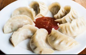 Order Steamed Chicken Momos (8 pcs) food online from Oasis Multicuisine store, Baton Rouge on bringmethat.com
