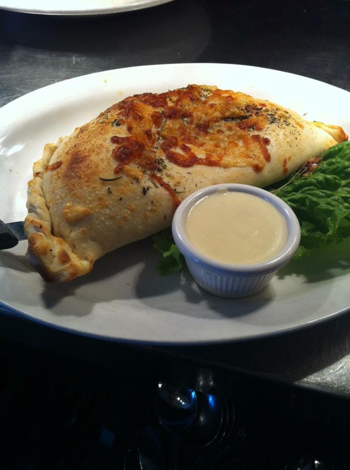 Order Meat Lover's Calzone - Calzone food online from Strings Italian Cafe store, Auburn on bringmethat.com