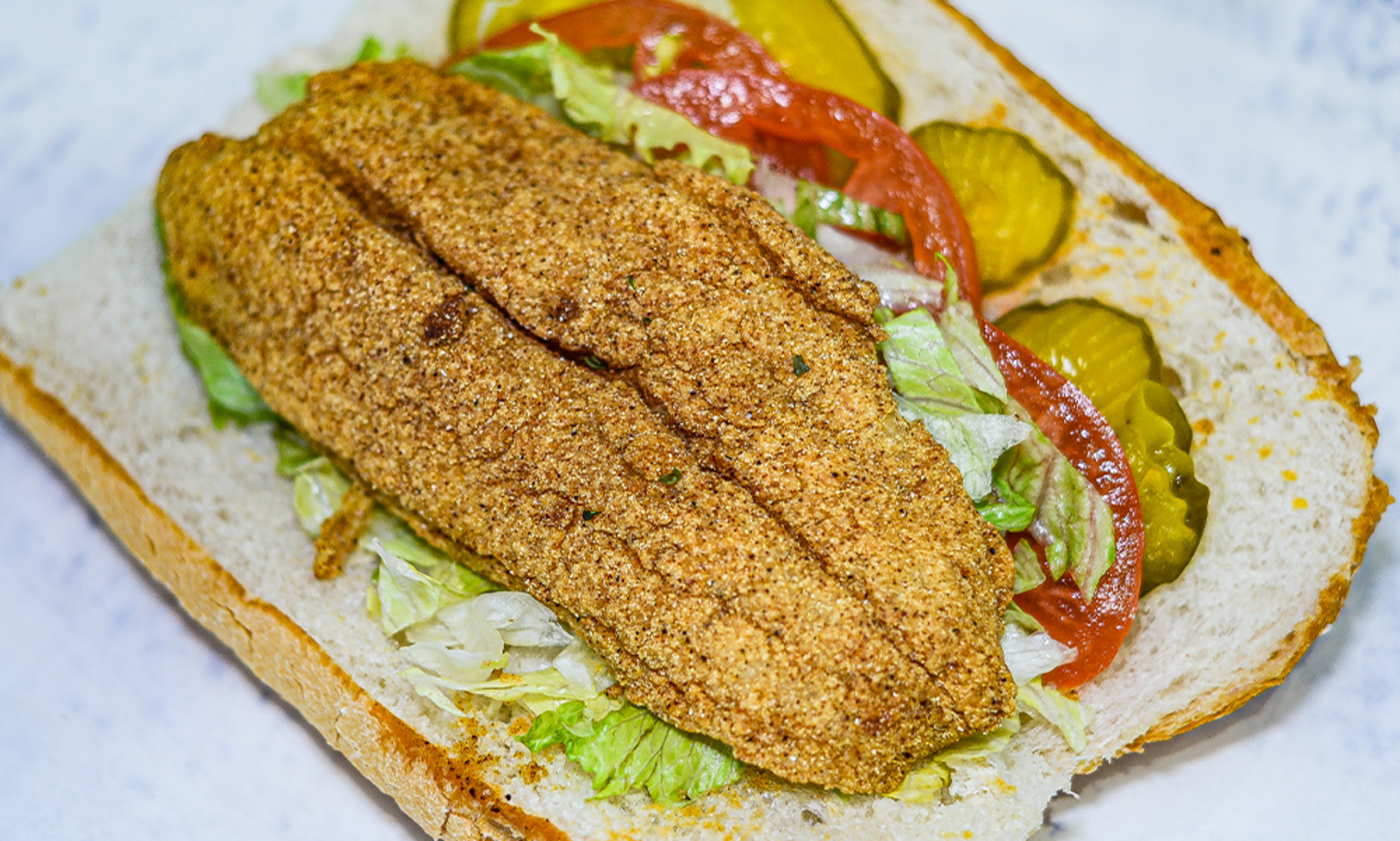 Order 8" Fish Po-Boy food online from The Station Seafood Co. store, Houston on bringmethat.com