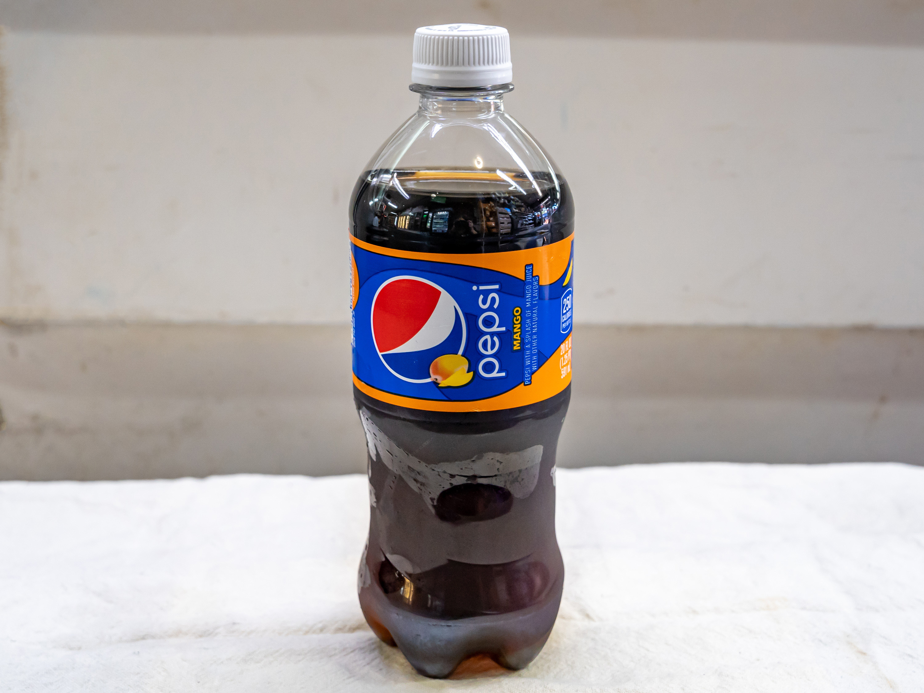Order Pepsi Mango -20oz bottle food online from Quentin Deli and Grocery store, Brooklyn on bringmethat.com