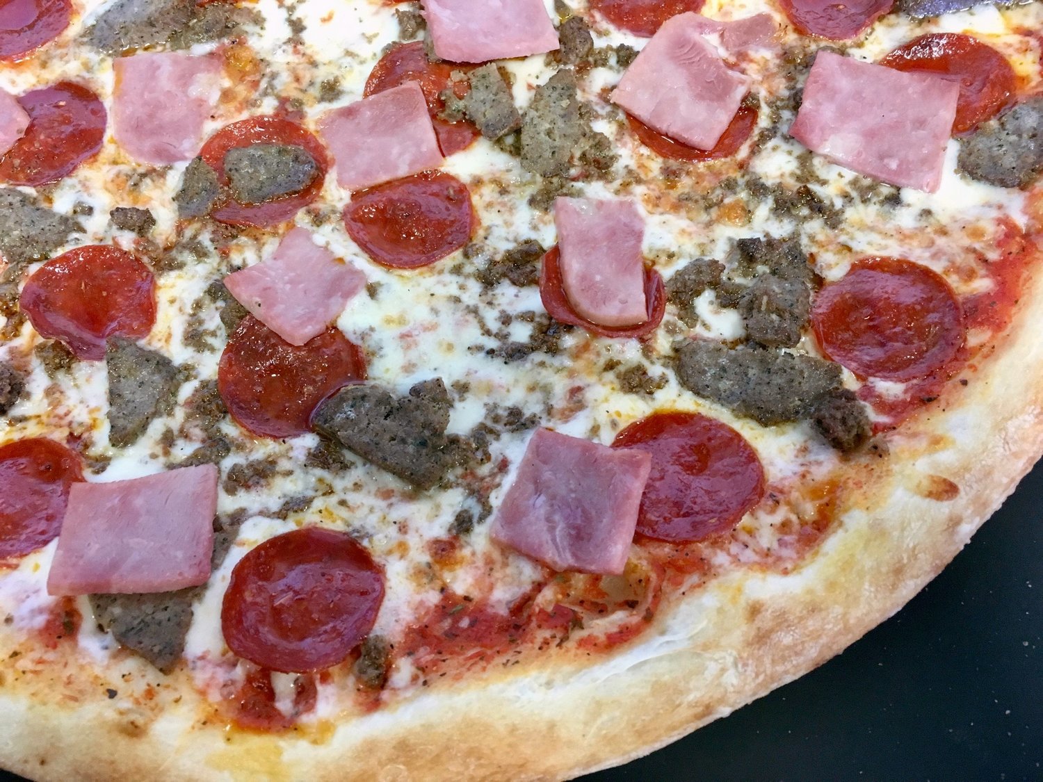 Order Meat Pizza food online from Yaghi Pizzeria store, San Antonio on bringmethat.com