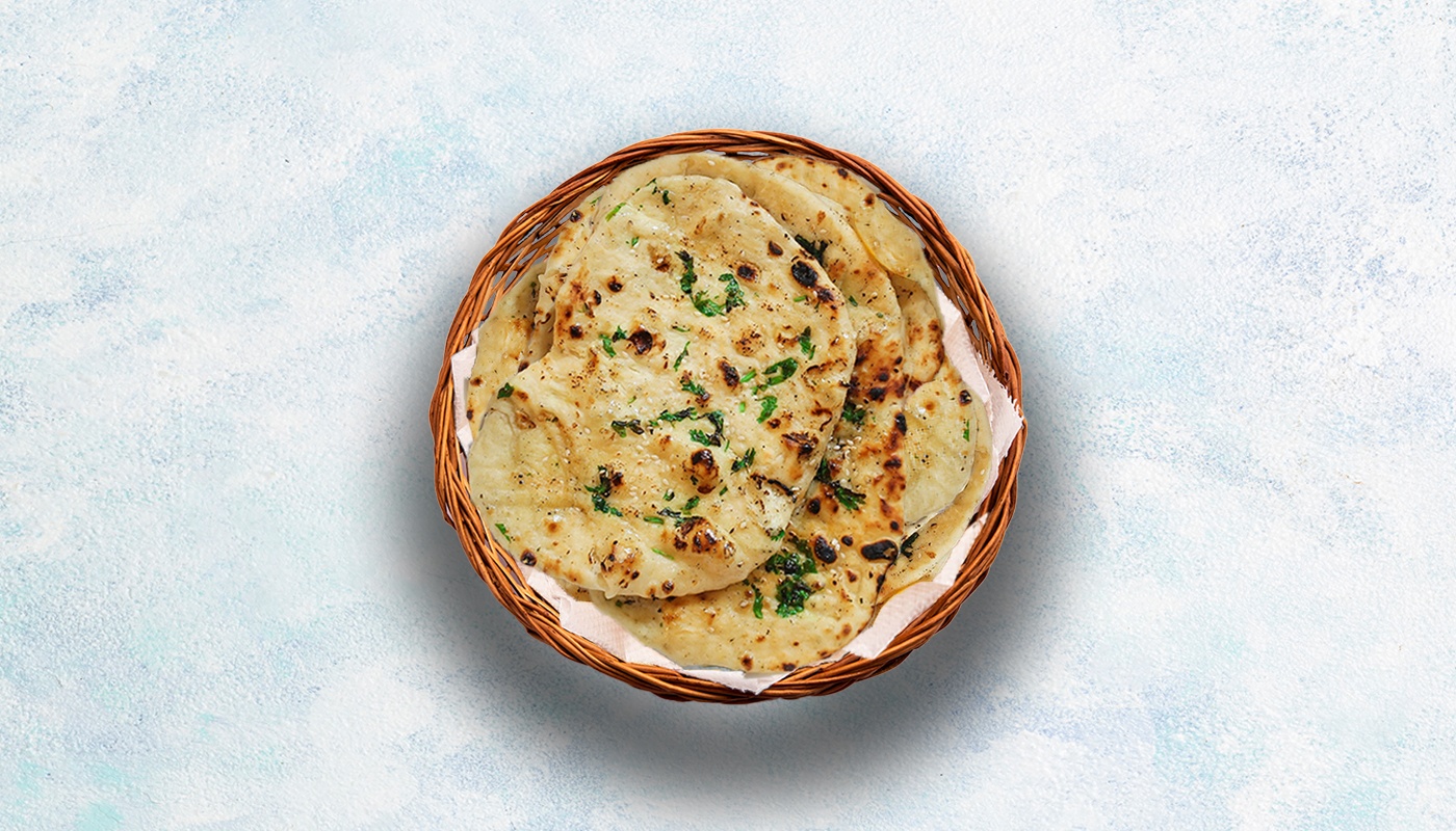 Order Garlic Naan food online from Curry Spoon store, Irving on bringmethat.com