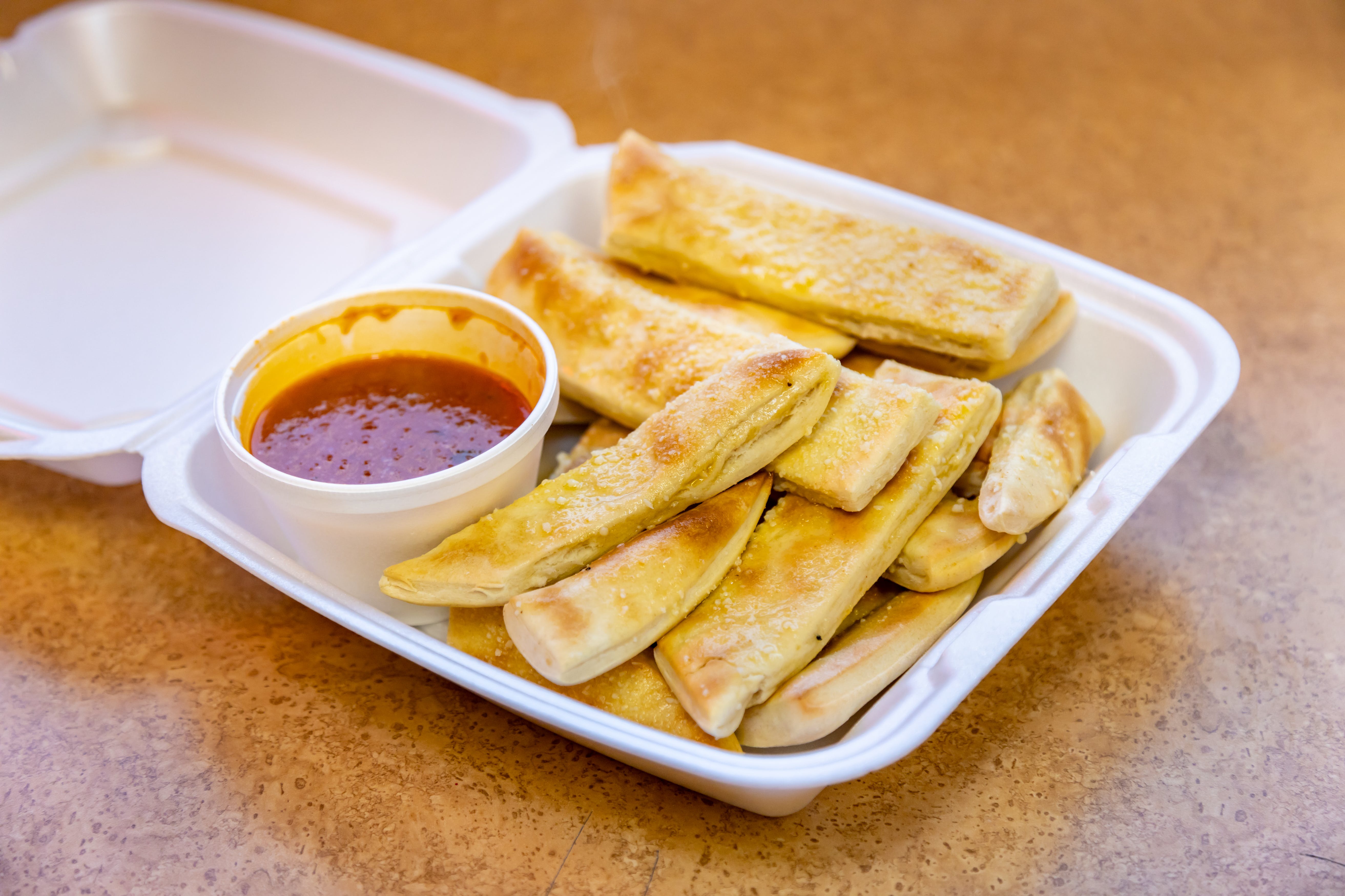 Order Homemade Bread Sticks with Sauce - 10-14 Pieces food online from Mario Pizza store, North Aurora on bringmethat.com