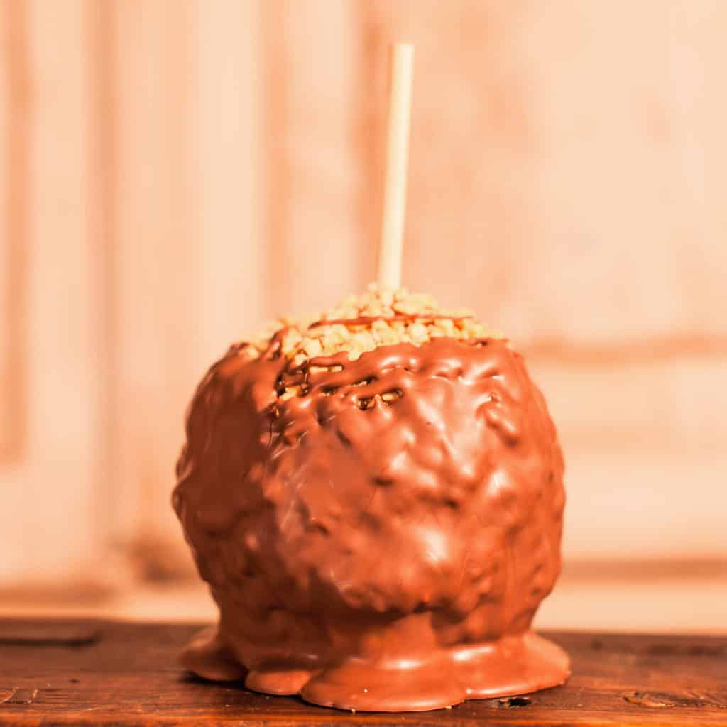 Order Peanut Caramel Apple with Milk Chocolate food online from Candy Apple Shoppe store, Glenwood on bringmethat.com