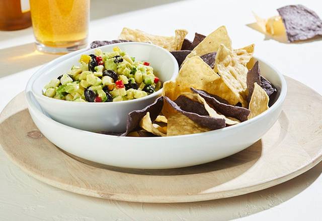 Order WHITE CORN GUACAMOLE + CHIPS food online from California pizza kitchen (cpk - short pump) store, Richmond on bringmethat.com