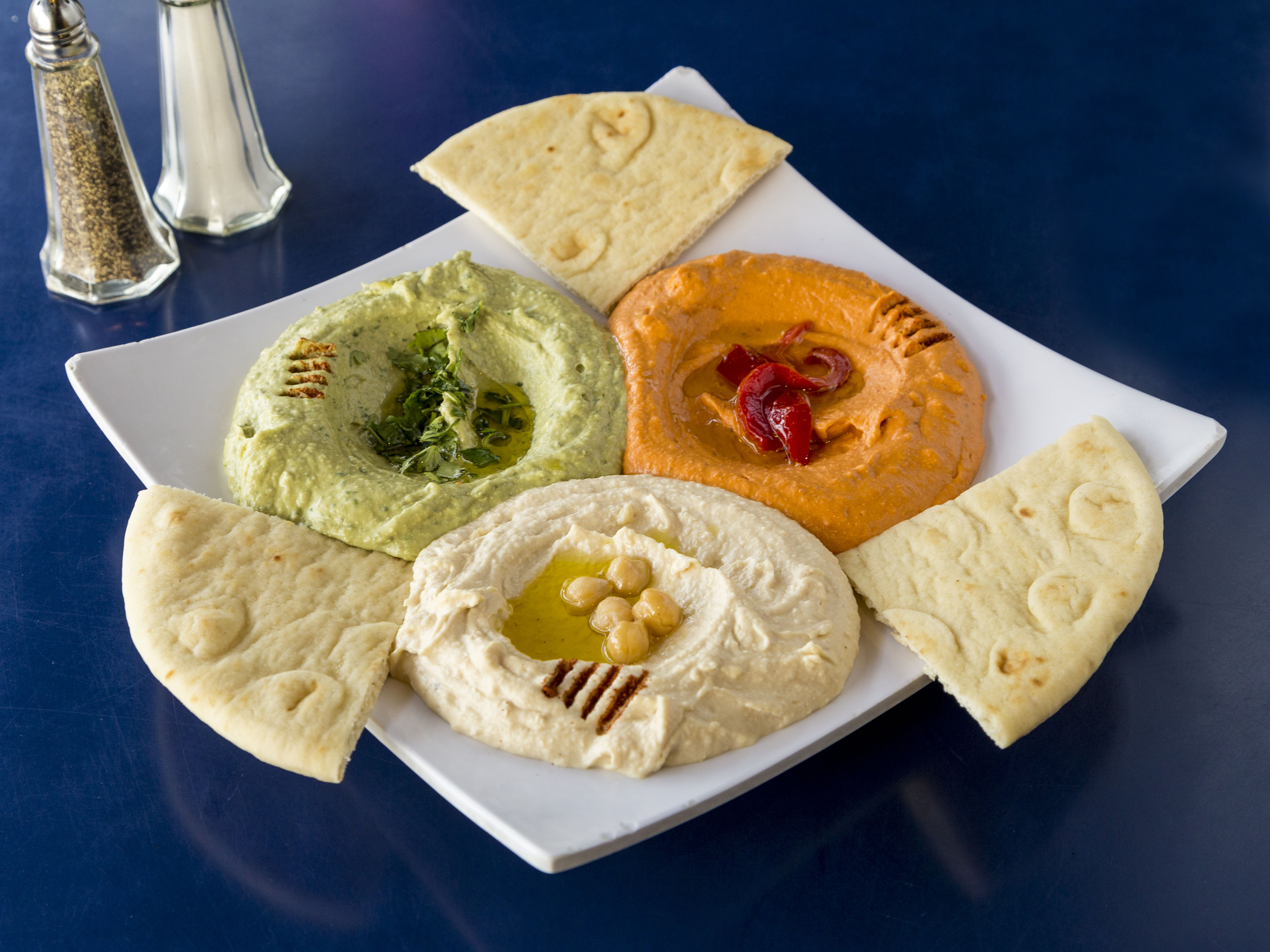 Order Trio Hommus food online from Phoenicia Cafe store, Gilbert on bringmethat.com