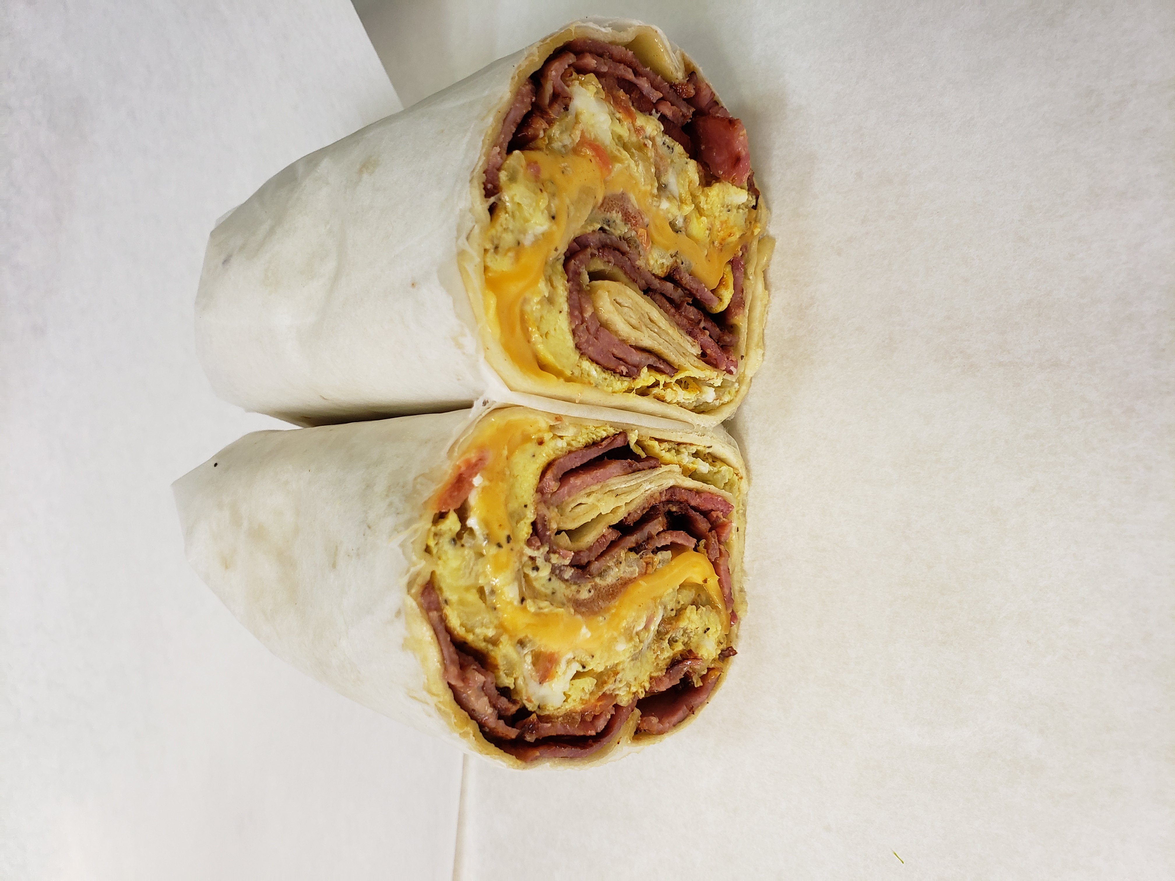 Order Egg Wrap with Turkey Bacon food online from S. Gardens Deli store, Springfield Gardens on bringmethat.com
