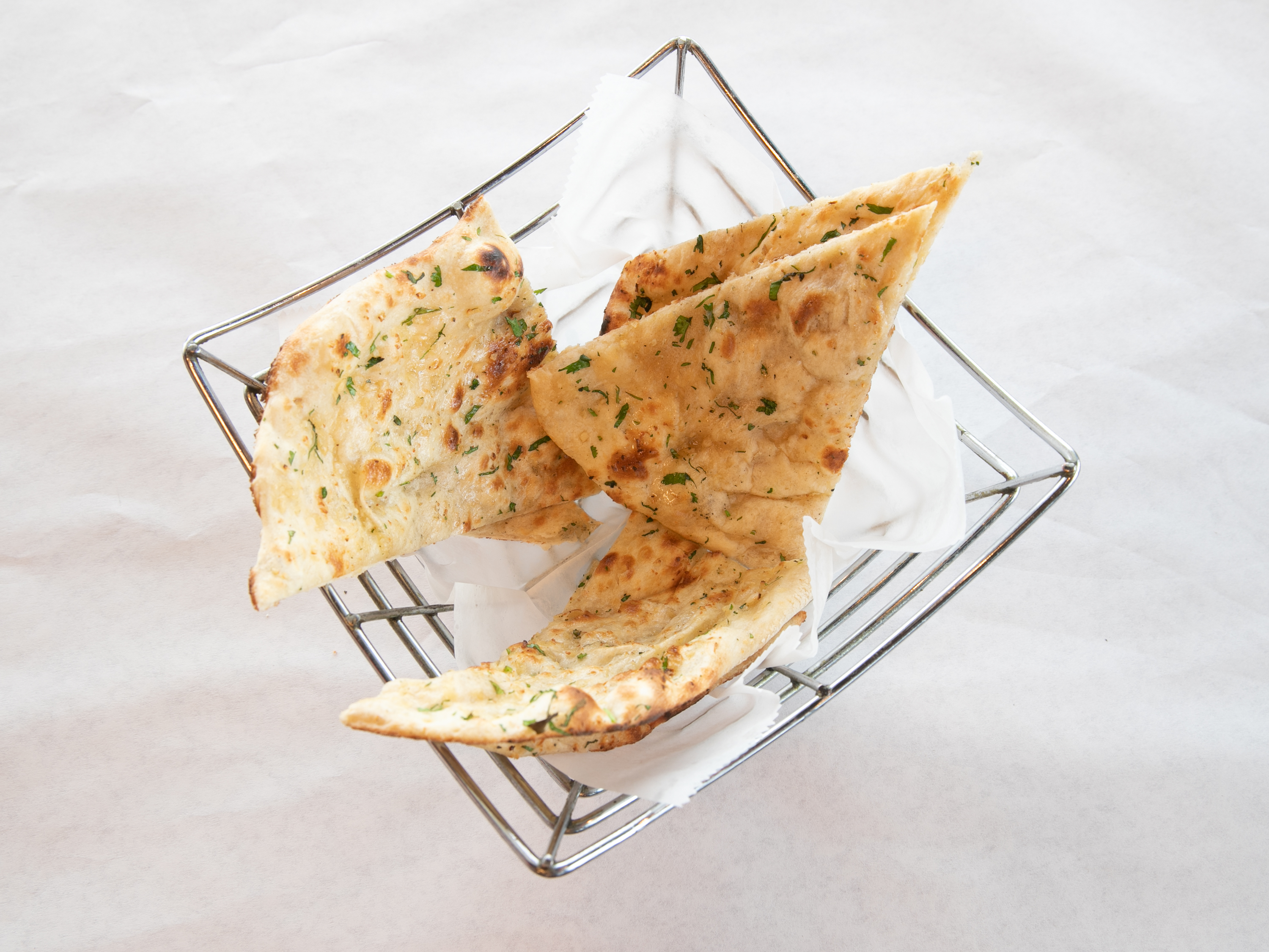 Order 73. Garlic Naan food online from Taste of the Himalayas store, St. Charles on bringmethat.com