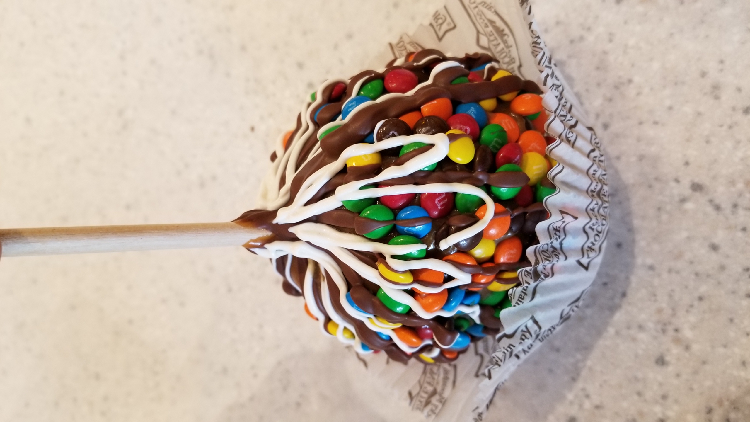 Order M&M Caramel Apple food online from Rocky Mountain Chocolate Factory store, La Grange on bringmethat.com