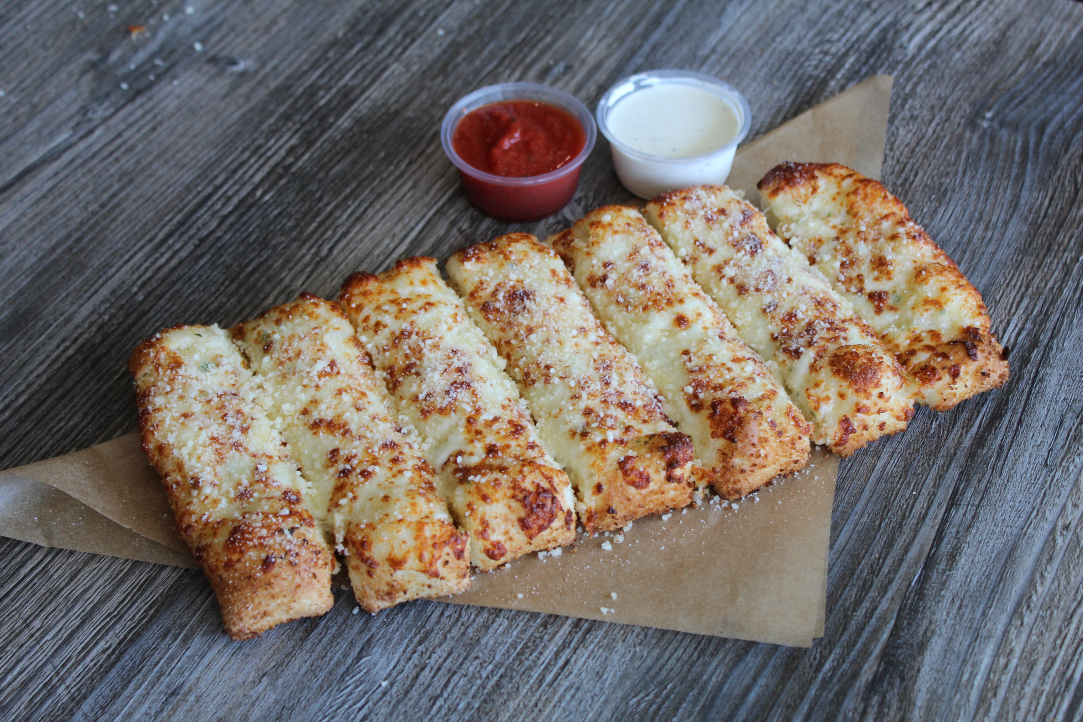 Order Bread Sticks with Mozzarella Cheese on Top food online from Canadian Pizza store, Long Beach on bringmethat.com