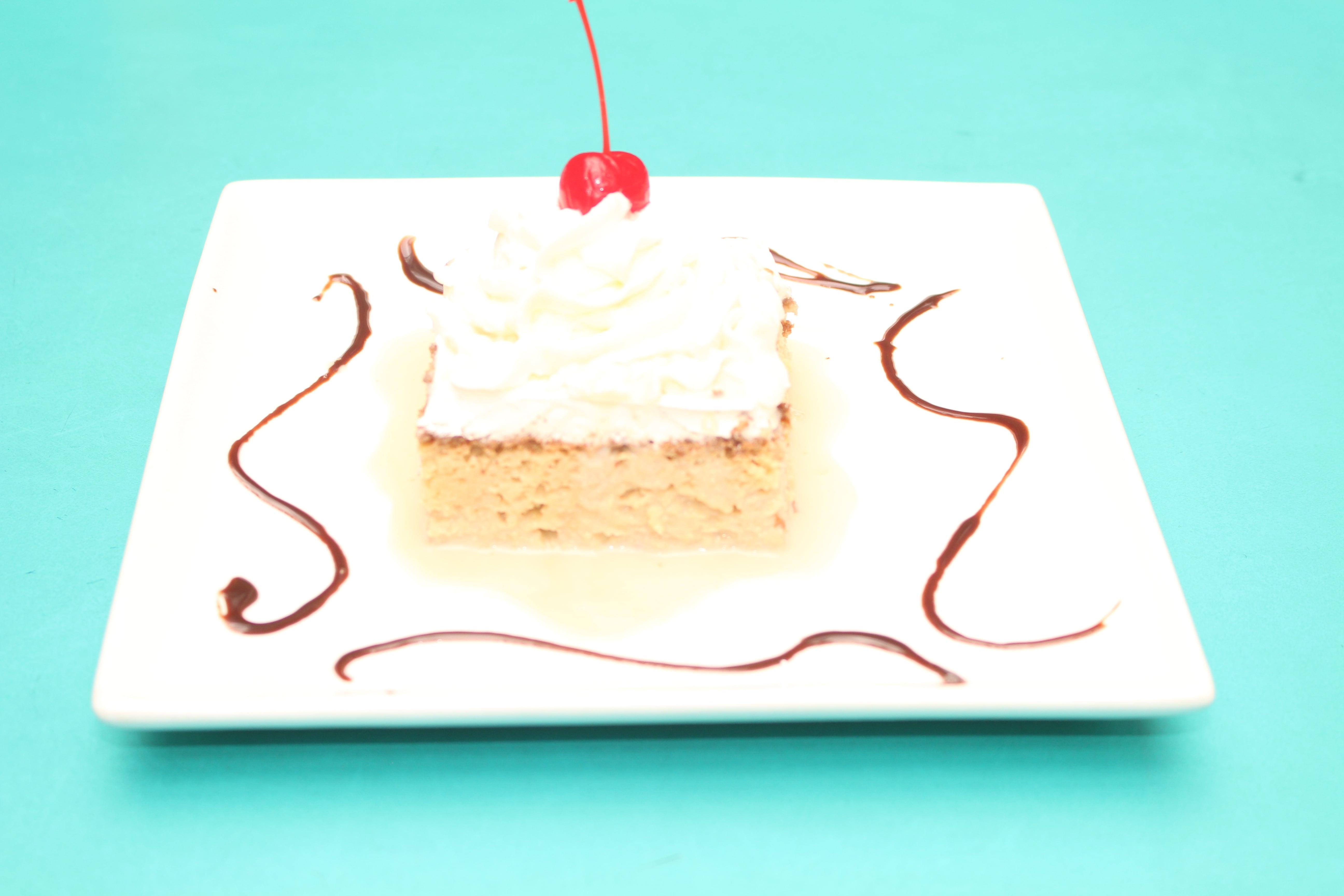 Order Pastel de Tres Leches to go food online from Refried Beans store, New York on bringmethat.com