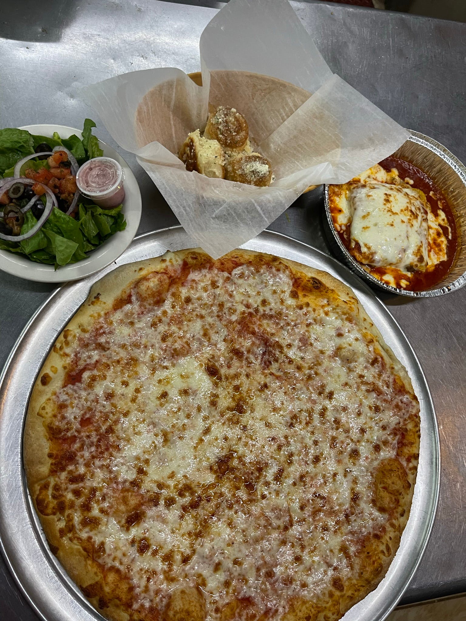 Order 16” Large Cheese Pizza, Pasta Dish, 2 Garlic Rolls & Side Salad Special - Special food online from Manhattan Chicago Pizza Kendall store, Miami on bringmethat.com