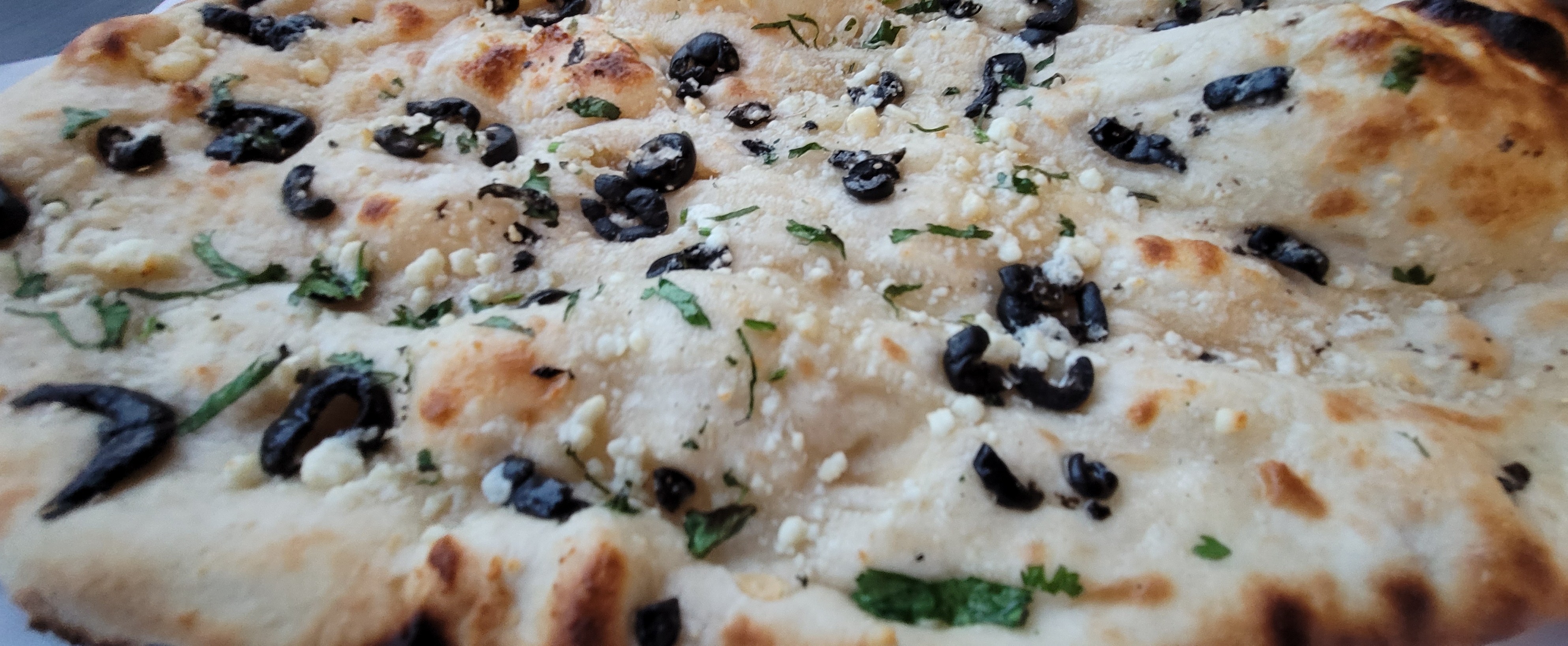 Order Black olives and Feta cheese Naan food online from Bon Appetikka store, San Francisco on bringmethat.com